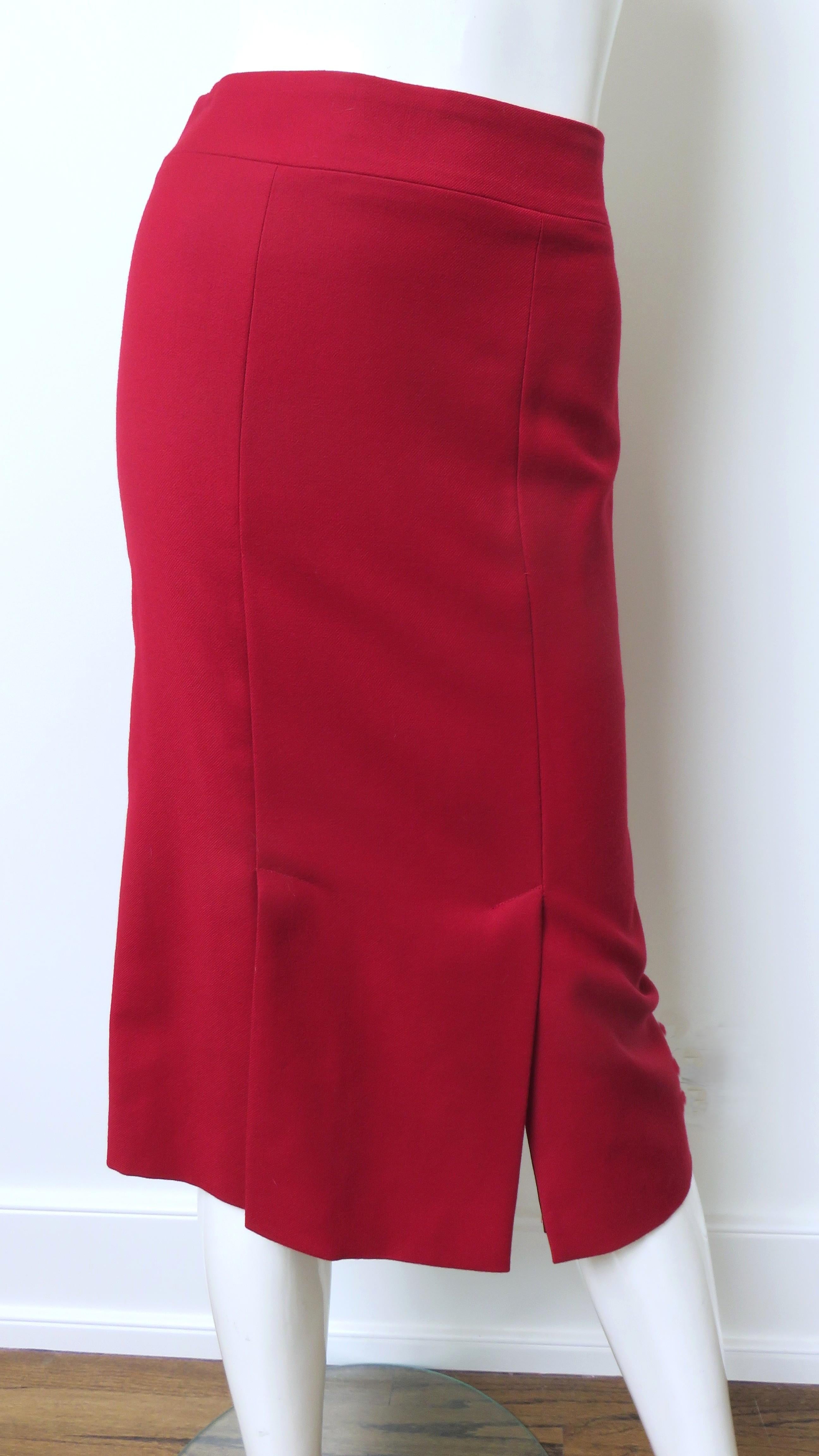 Una estupenda falda roja de lana de Alexander McQueen.  Tiene una cintura configurada como prolongación de la falda, cremallera lateral y paneles verticales que incorporan  Aberturas en el dobladillo delantero. Está totalmente recubierto de