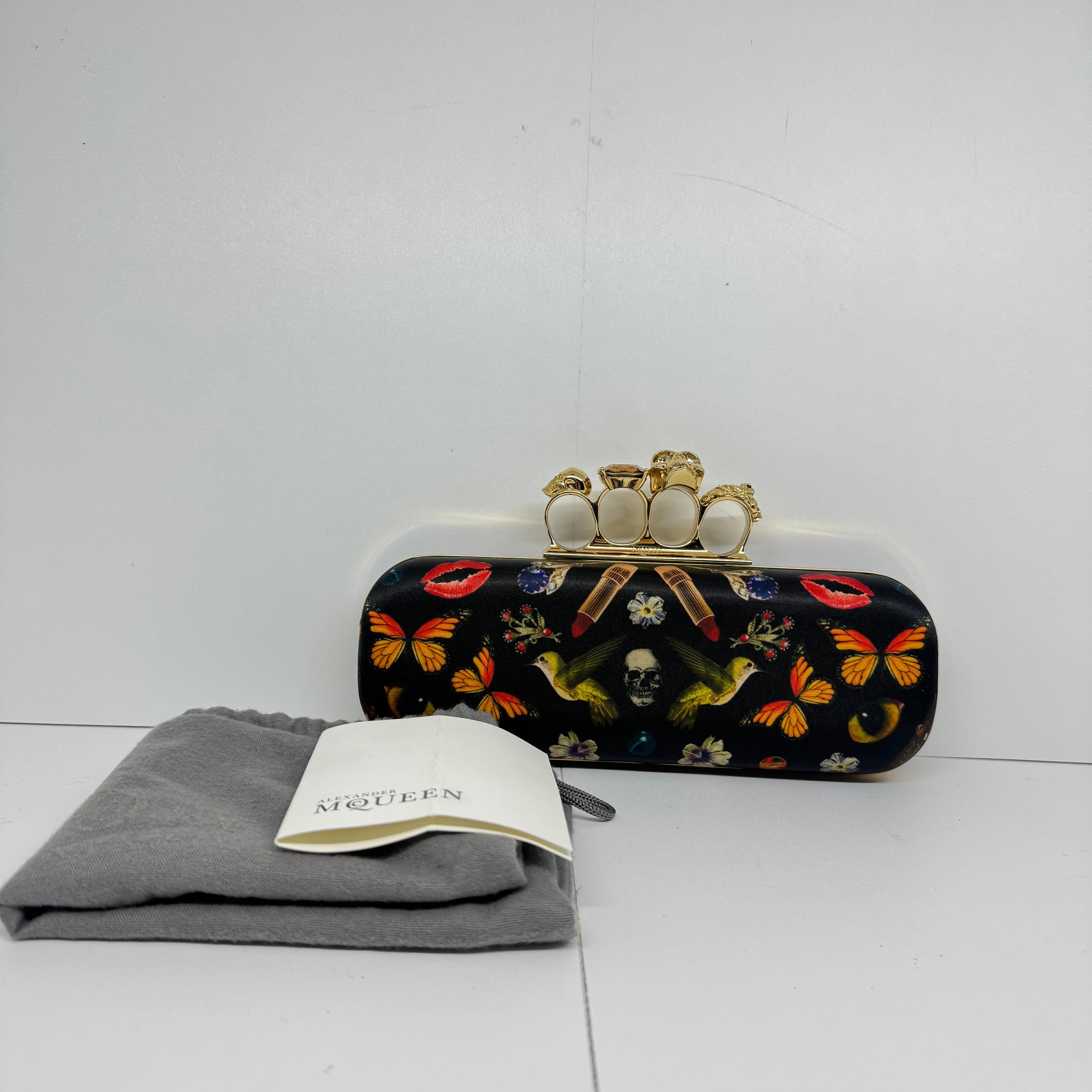 The iconic knuckle clutch. Still in excellent condition, only minor scuffing and tarnishing on the hardware. Minor press marks on the leather lining. Iconic collection. Comes with its dust bag.