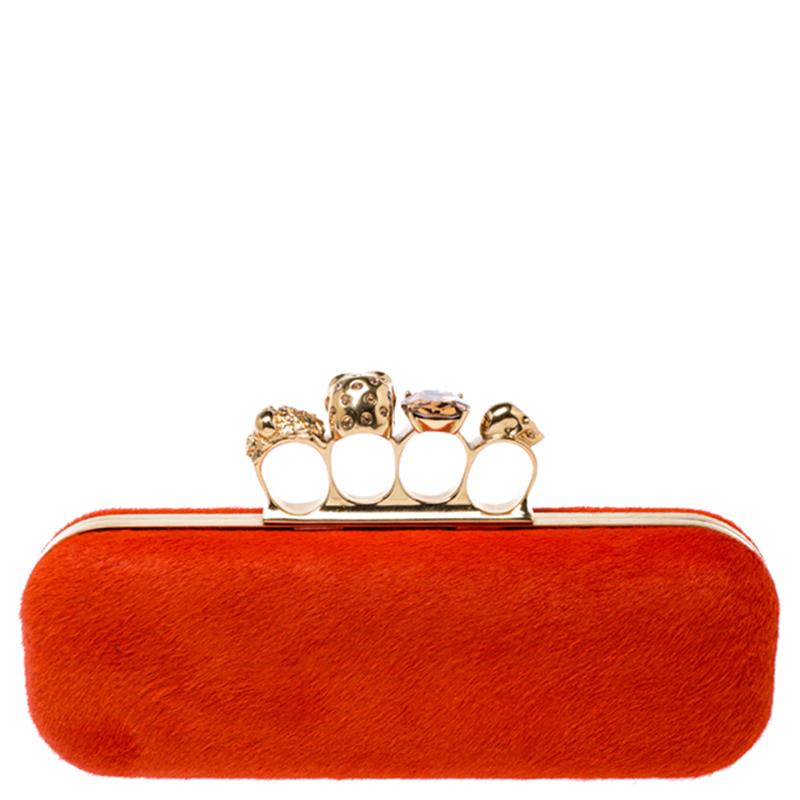 This Box Clutch from Alexander McQueen exudes versatility and luxury. Crafted from calf hair, it has a grand finish and comes with a leather interior. This piece is complete with the brand's iconic skull-knuckle slot on top. Flaunt this orange