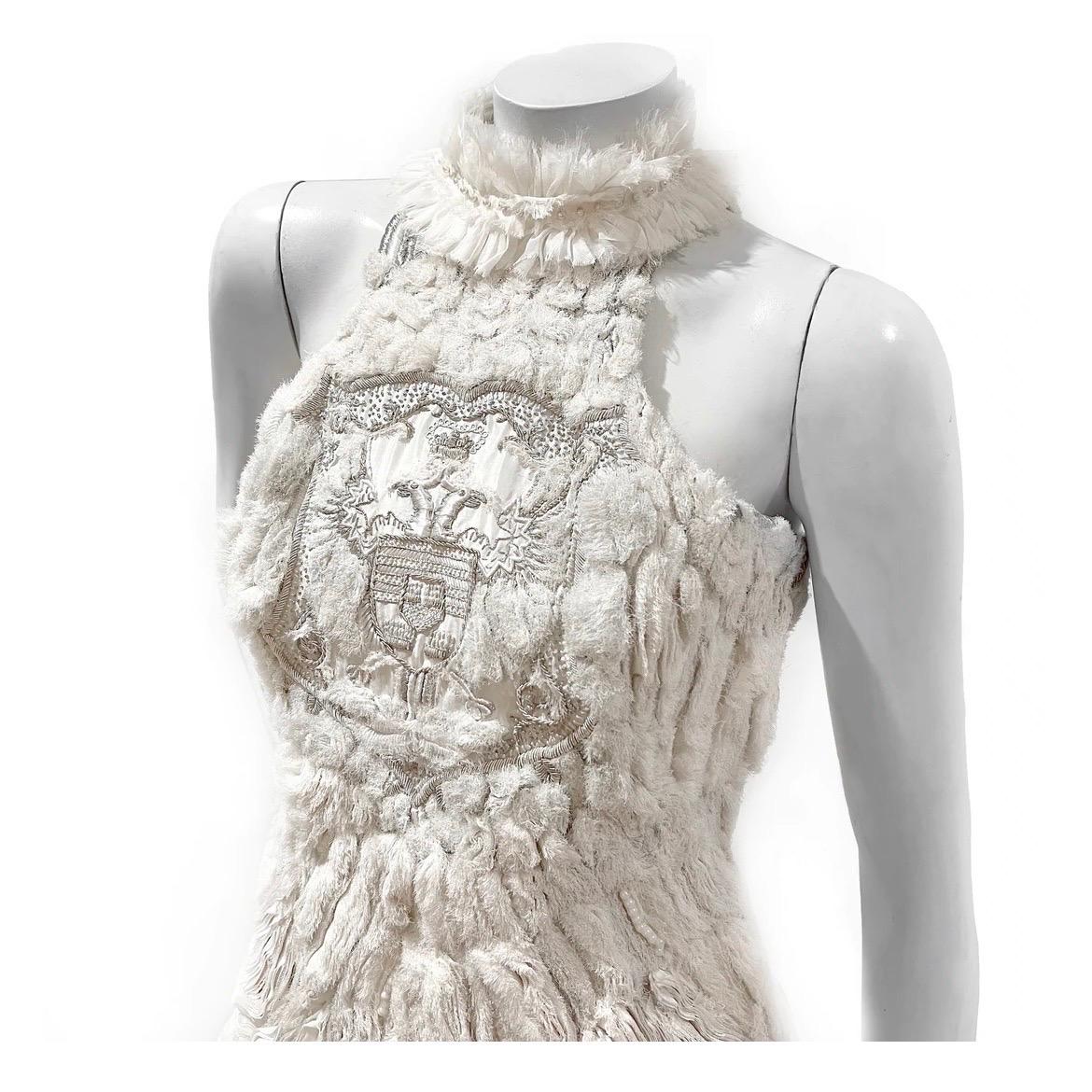 Ornate halter dress by Sarah Burton for Alexander McQueen
Fall 2011 Ready-to-Wear
Look 24
Made in Italy 
White and off-white 
Internal, attached corset
Layered cotton, mesh and chiffon throughout 
Silver and gold embroidered regal detail at
