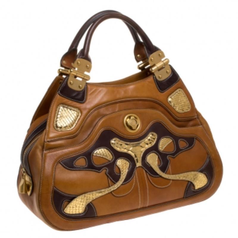 One cannot go wrong with a piece like this from Alexander McQueen satchel. Get ready to grab a lot of praises for your awesome appearance with this smart and trendy leather bag accented with snakeskin trims. This tan satchel comes with dual handles,