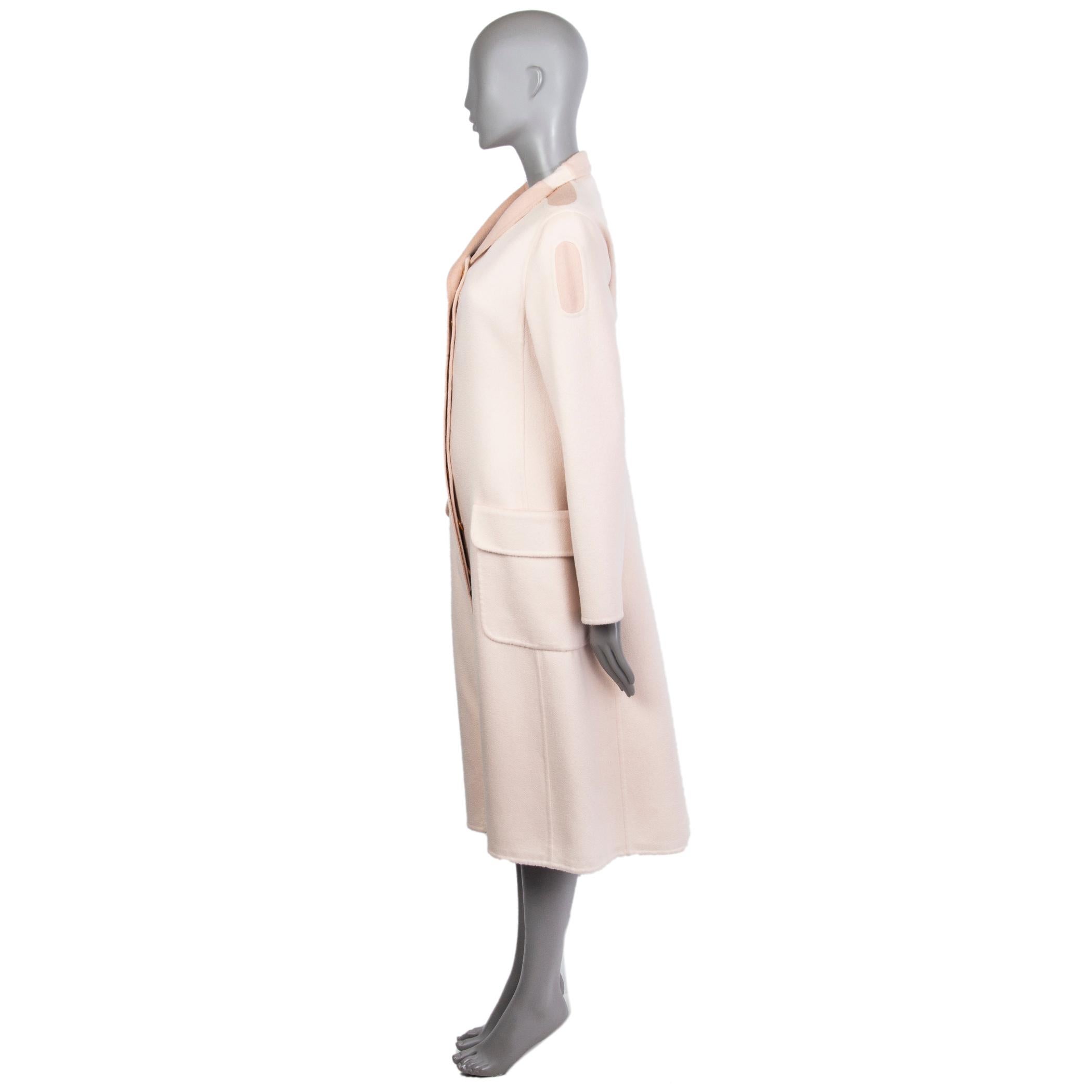 Alexander McQueen coat in light and deco rose cashmere (100%). With slit neck, shoulder patches, two flap pockets on the sides, slit on the back, and weight chain around the inside of the hemline. Unlined. Has been worn and is in excellent