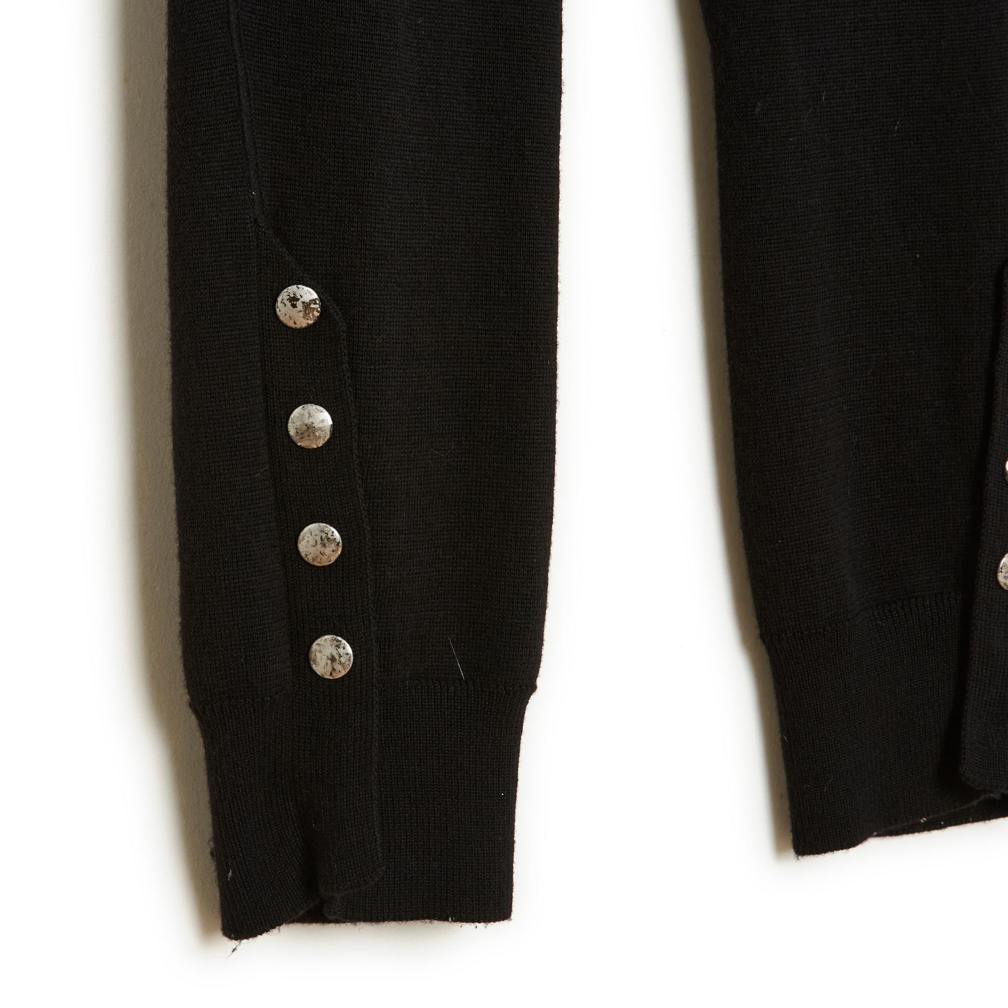 Alexander McQueen legging pants in black wool, jersey knit with mesh reinforcement at the crotch down to the ankles, riding style, elastic waist, bottom of the leg closed with 6 snaps, 4 of which are decorated with silver metal jewelry buttons. Size