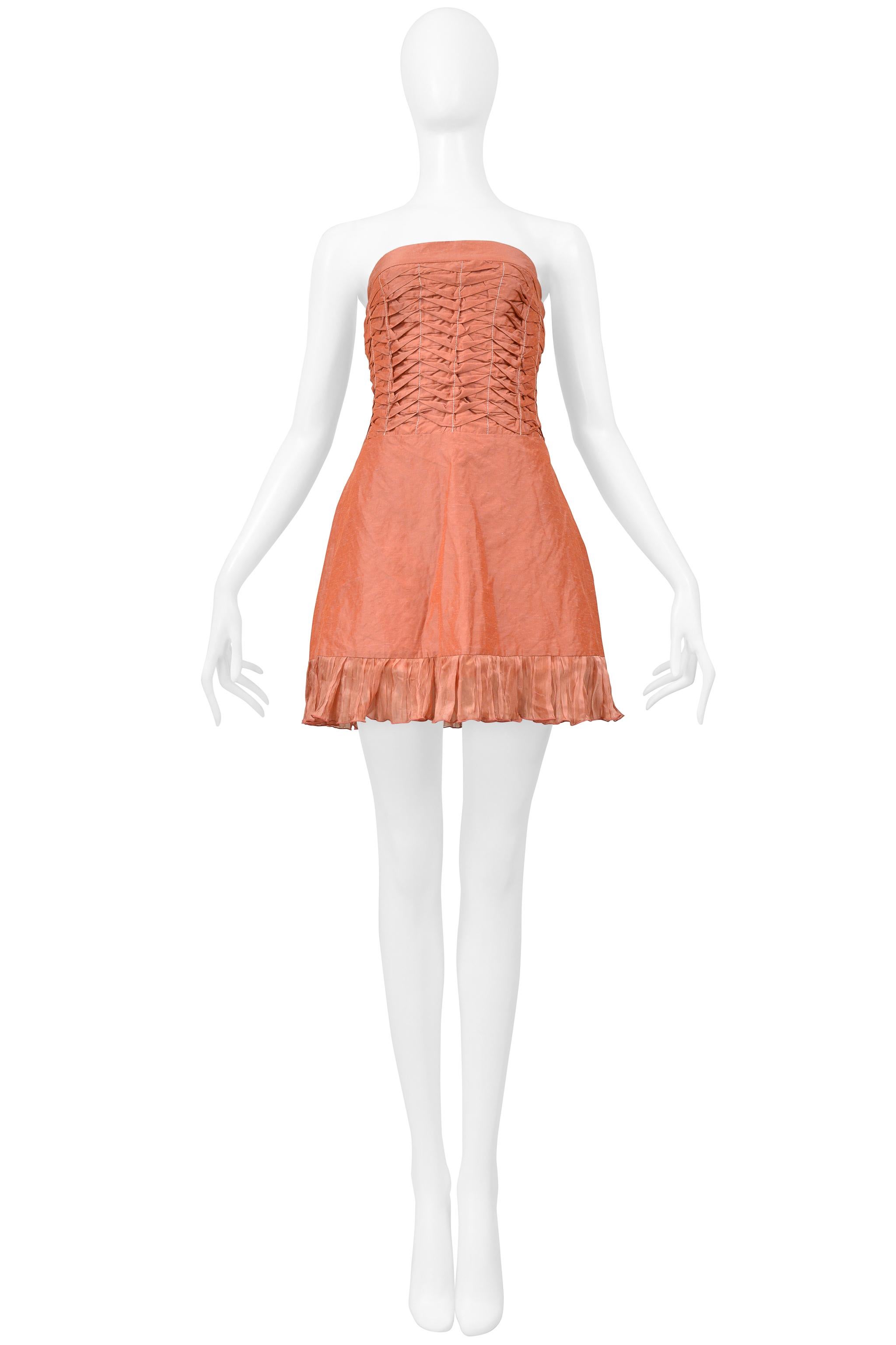 Resurrection Vintage is thrilled to offer a vintage Alexander McQueen pink pleated strapless dress featuring a pleated bodice, ruffled hem, bell silhouette, and invisible zipper at the side and above-the-knee length. This dress has never been worn