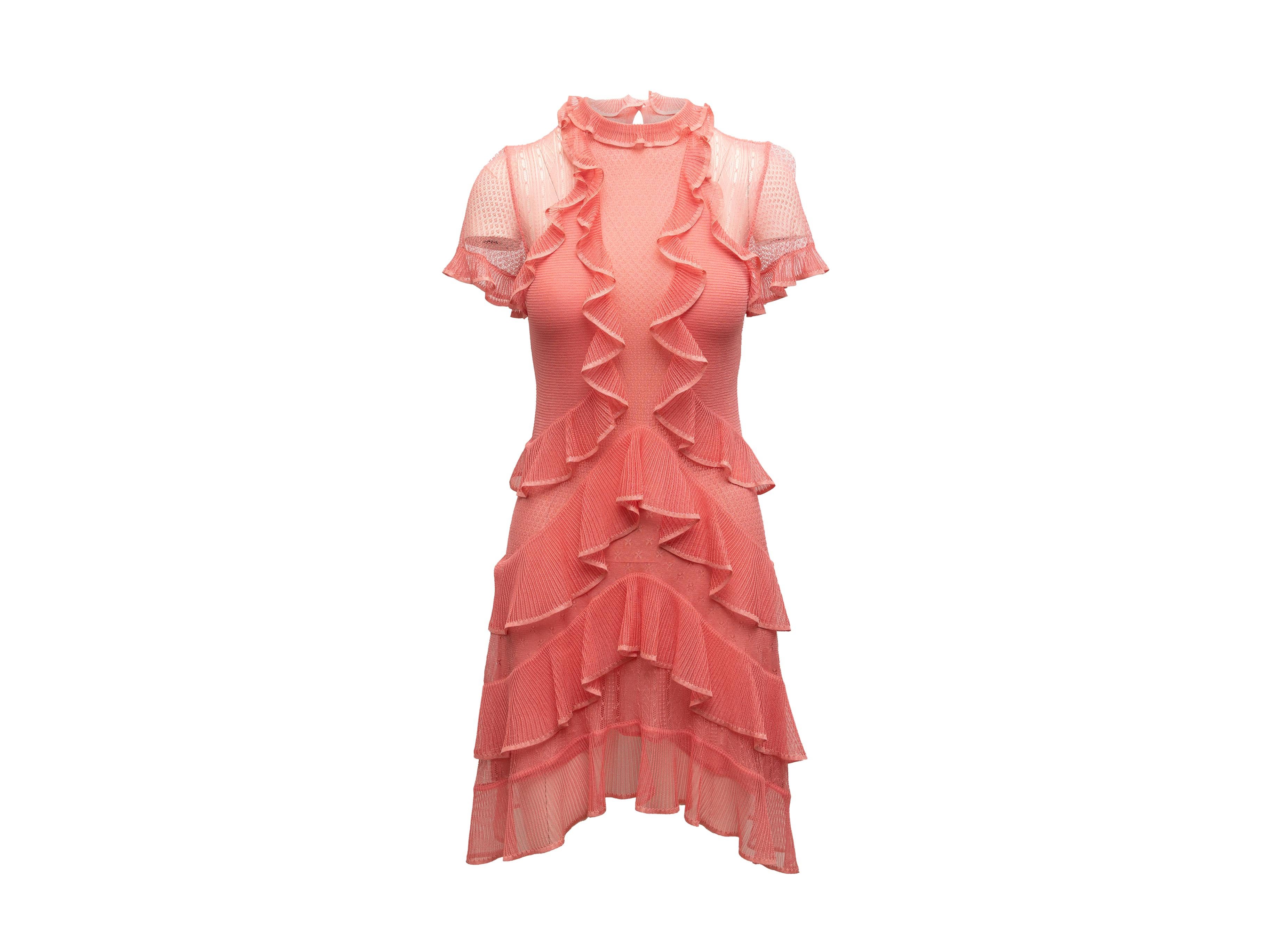 Product details: Pink silk knit short sleeve dress by Alexander McQueen. Ruffle detailing throughout. Crew neck. Asymmetrical hem. Keyhole at nape featuring button closure. 27