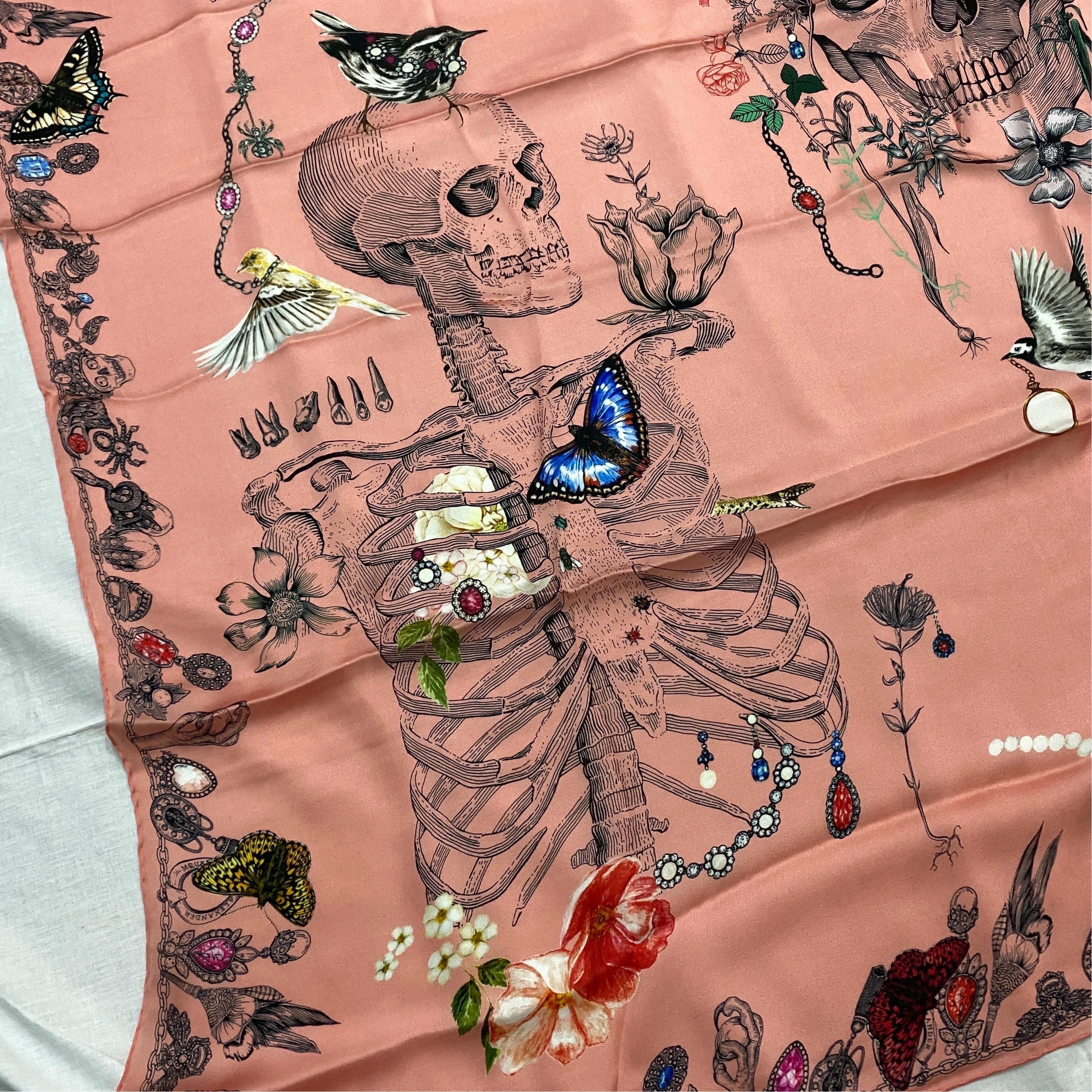 An iconic Alexander McQueen Pink Silk Scarf decorated with skulls, flora and fauna. 
Dimension 135 x 135 cm .