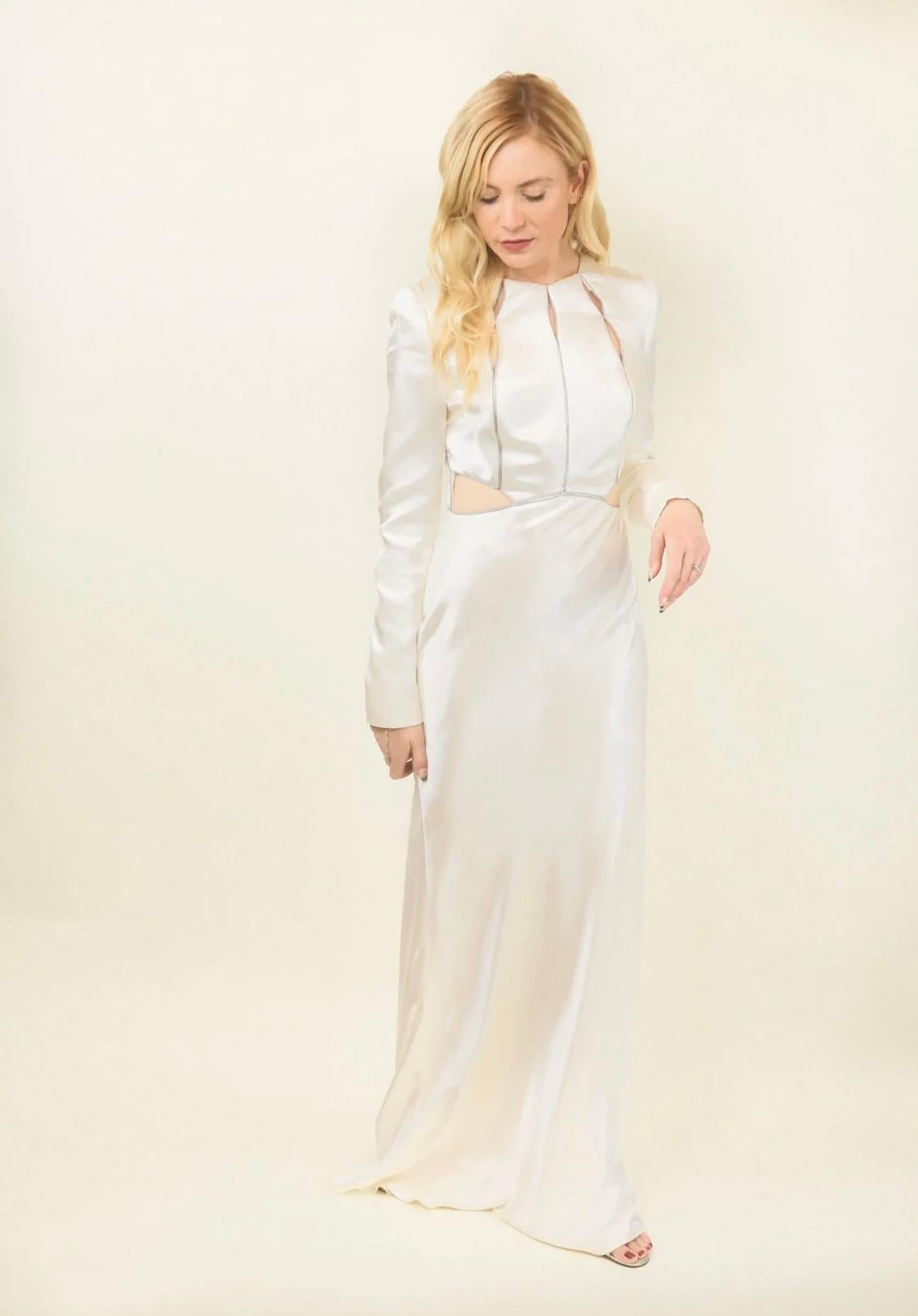 Finding a vintage designer white gown is in itself a difficult task.  Our white gown with waist cut outs is from iconic designer, Alexander McQueen. This is truly one of a kind. From the pre fall 2014 collection, it has cut outs at the waist and