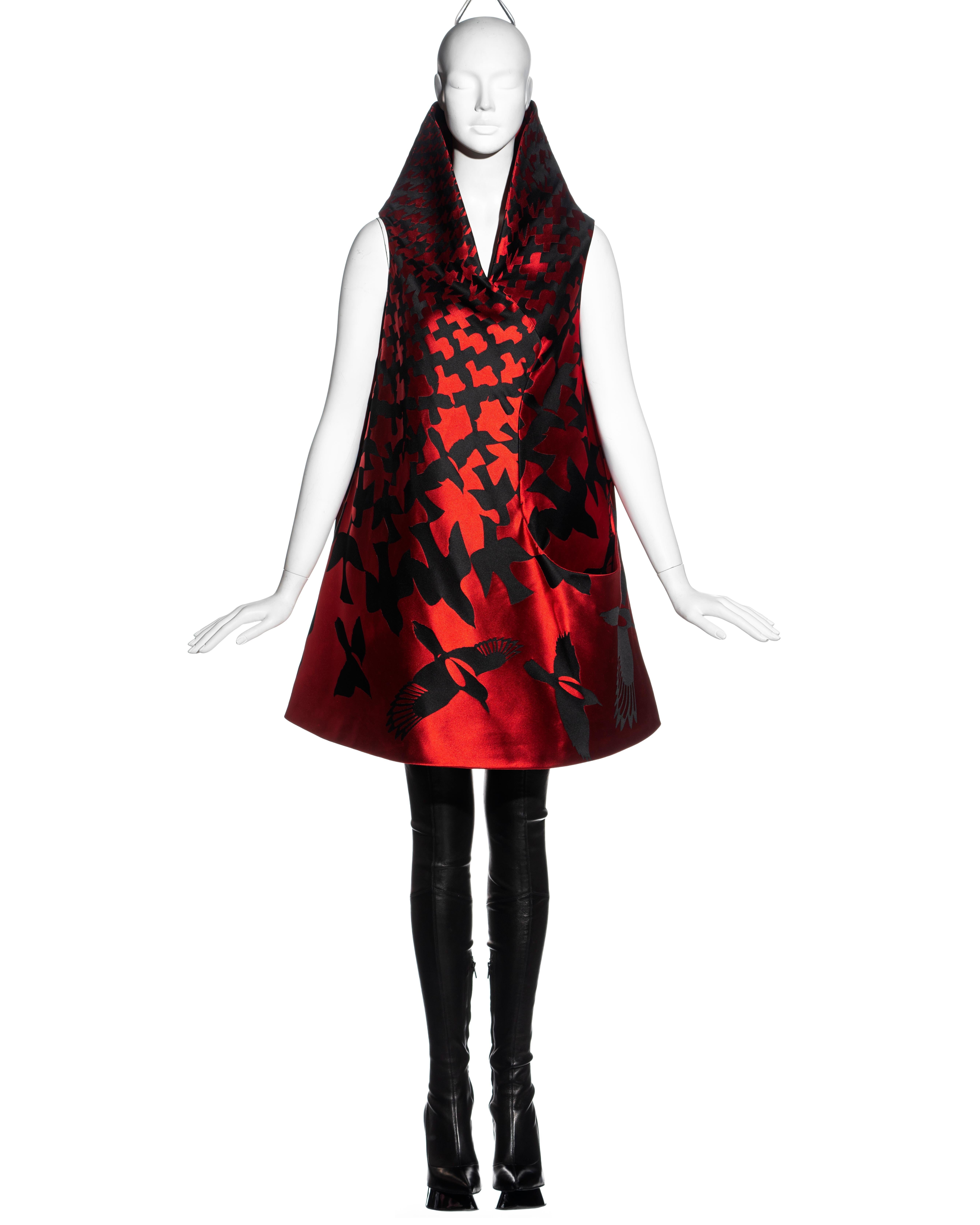 ▪ An important Alexander McQueen 'Horn of Plenty' evening dress
▪ Red and black silk jacquard 
▪ Hound's tooth check print enlarging from the collar, morphing into birds in flight
▪ A-line 
▪ High neck standing collar 
▪ Open pocket at the hip 
▪ IT