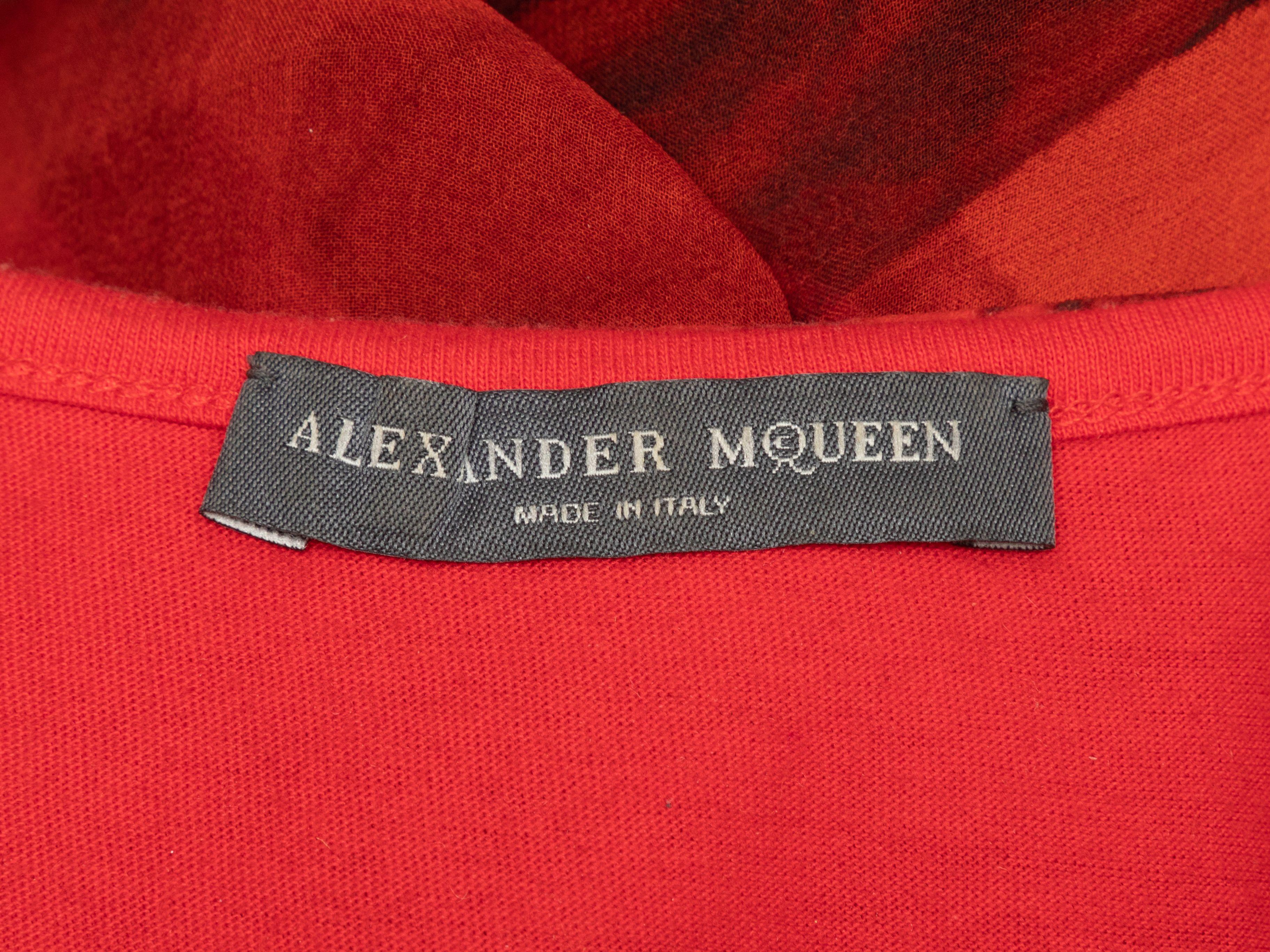 Product Details: Red and black silk floral print top by Alexander McQueen. Crew neck. Short dolman sleeves. 30