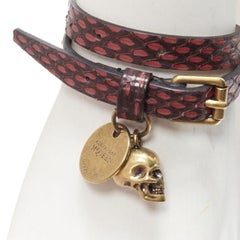 ALEXANDER MCQUEEN - Bracelet double manchette avec breloque tête de mort en cuir rouge noir écaillé
