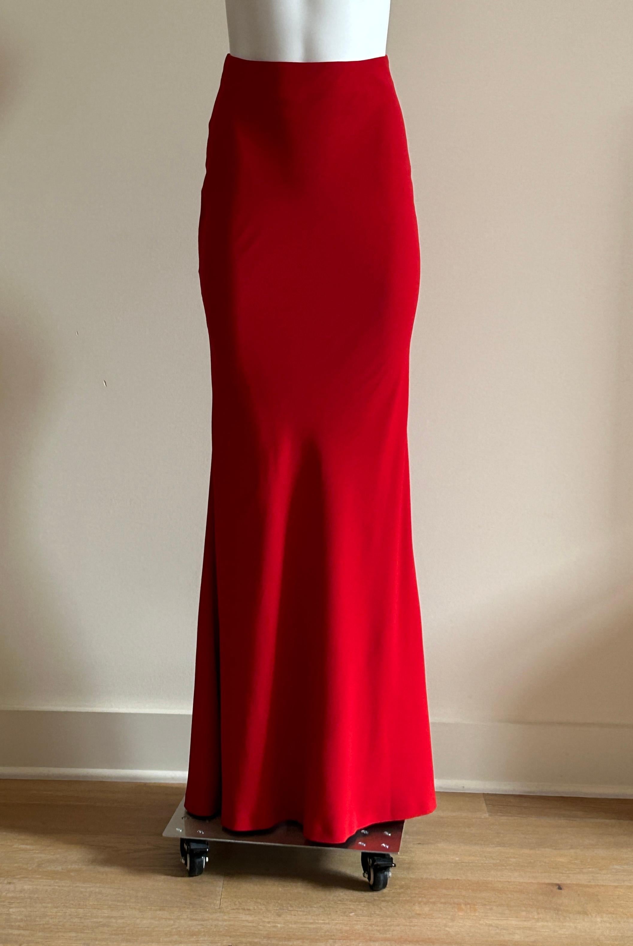 Alexander McQueen red full length maxi skirt with slight train in synthetic crepe. Back zip and hook and eye. Circa 2015 by Sarah Burton.

50% acetate, 50% viscose.
Fully lined in 100% silk.

Made in Italy.

Size IT 38, approximate US 2.
Waist