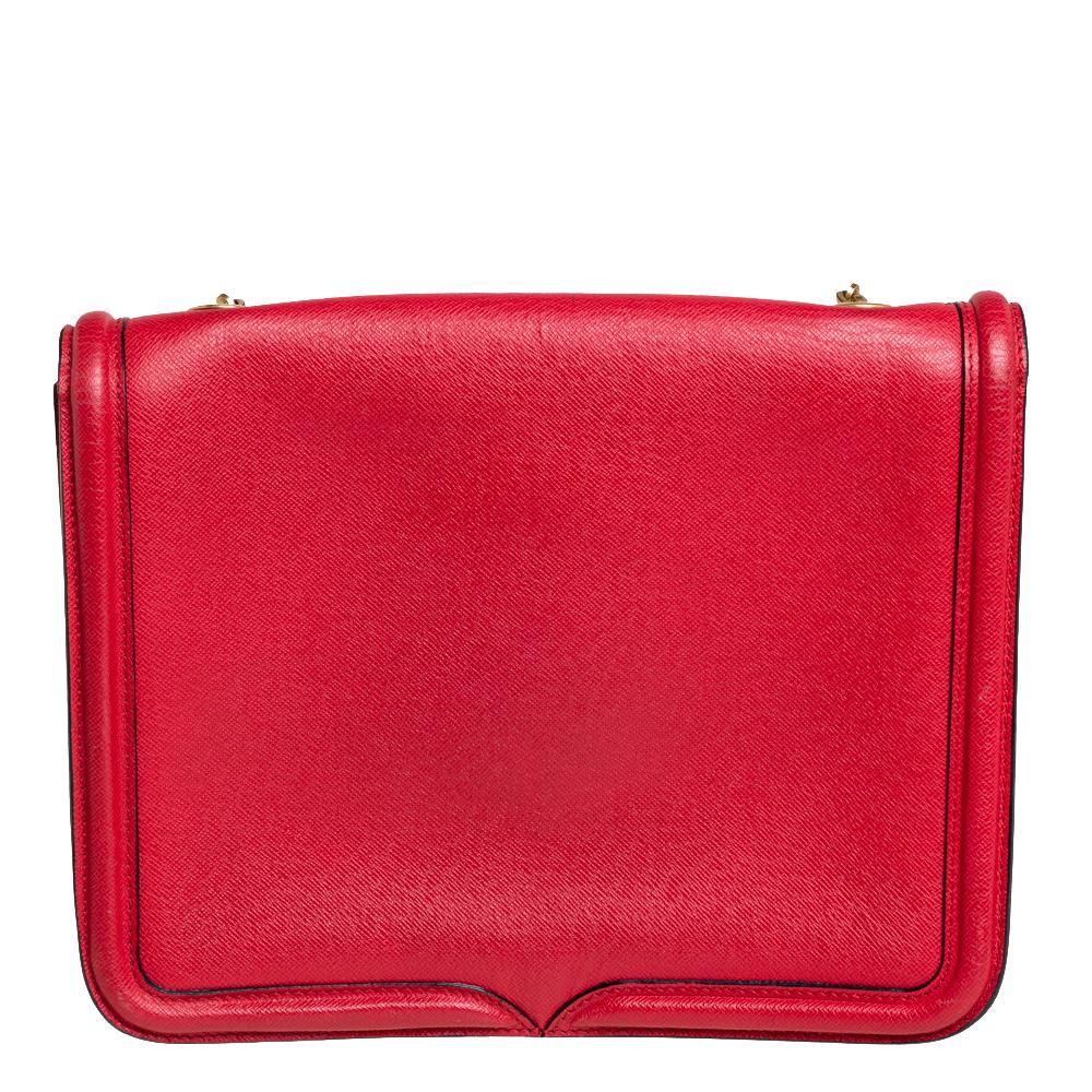 Every woman needs a bag that is pretty and functional, just like this shoulder bag from Alexander McQueen. Crafted from red-hued leather, it has been styled with a flap leading to a spacious suede interior and it is held by a strap. This is
