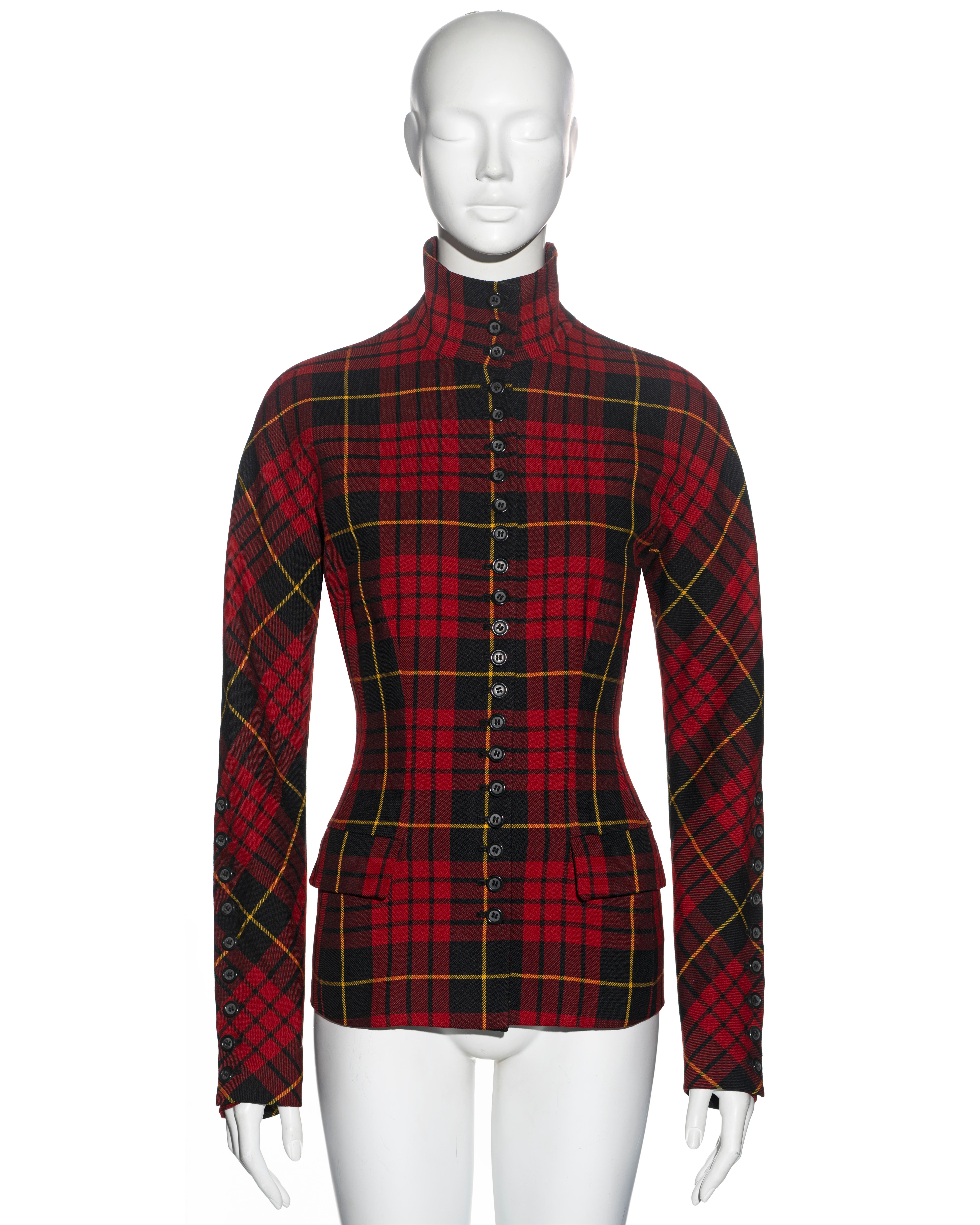 ▪ Alexander McQueen tailored 'Joan' jacket
▪ Sold by One of a Kind Archive 
▪ Museum quality
▪ Constructed from red and black tartan wool 
▪ Twenty-one buttons to the front and nine to each sleeve
▪ Standing collar 
▪ Two front flap pockets 
▪ Lined