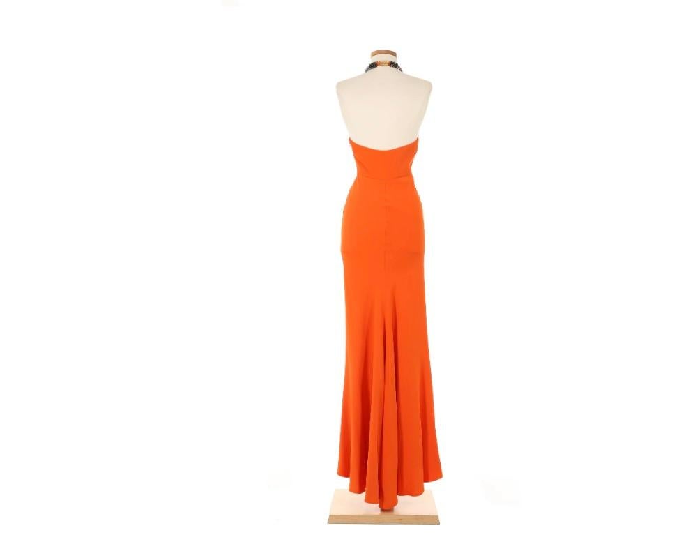 VINTAGE GRACE NY

A striking embodiment of McQueen’s bold yet refined aesthetic, this gown stuns in a vibrant orange hue. The sleek halter neckline is adorned with an intricate embellished collar, adding a touch of regal edge. Expertly tailored to