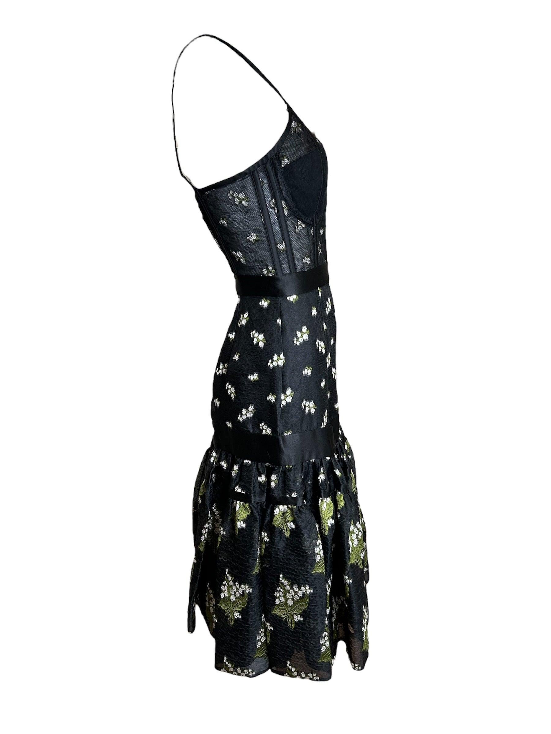 From Alexander McQueen's 2016 Resort collection comes this sexy bustier-centric dress. We are getting major Italian va-va-voom energy from this piece, with the greenery motif across. We could see 1950s starlets Sophia Loren or even Brigitte Bardot