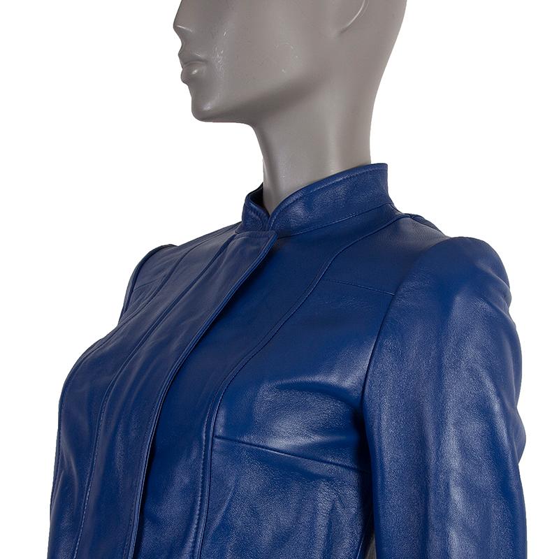 Alexander McQueen mandarin-collar jacket in royal blue leather. With zippered pleat on each cuff and two slits on the back. Closes with concealed snaps and double-sided zipper on the front. Lined in nude silk (100%). Has been worn and is in