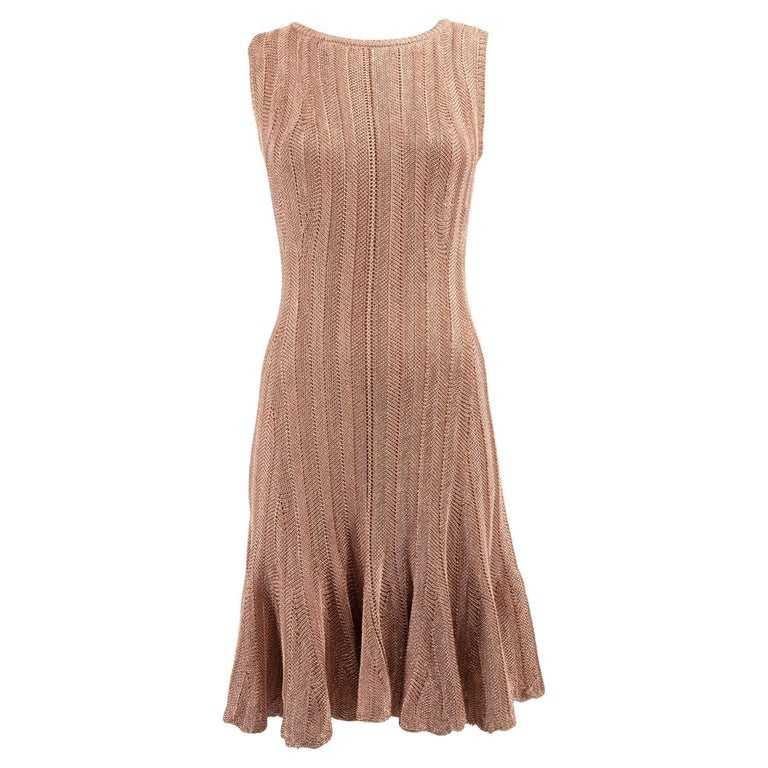 Alexander McQueen Women's Sleeveless Ruffled Champagne Rose Gold Metallic Cocktail Dress
Details:
-	Metallic pink Viscose Sleeveless dress Bodycon Flared skirt 
-	Striped knit patterned 
-	Fisheye keyhole with button on back 
-	Fully lined