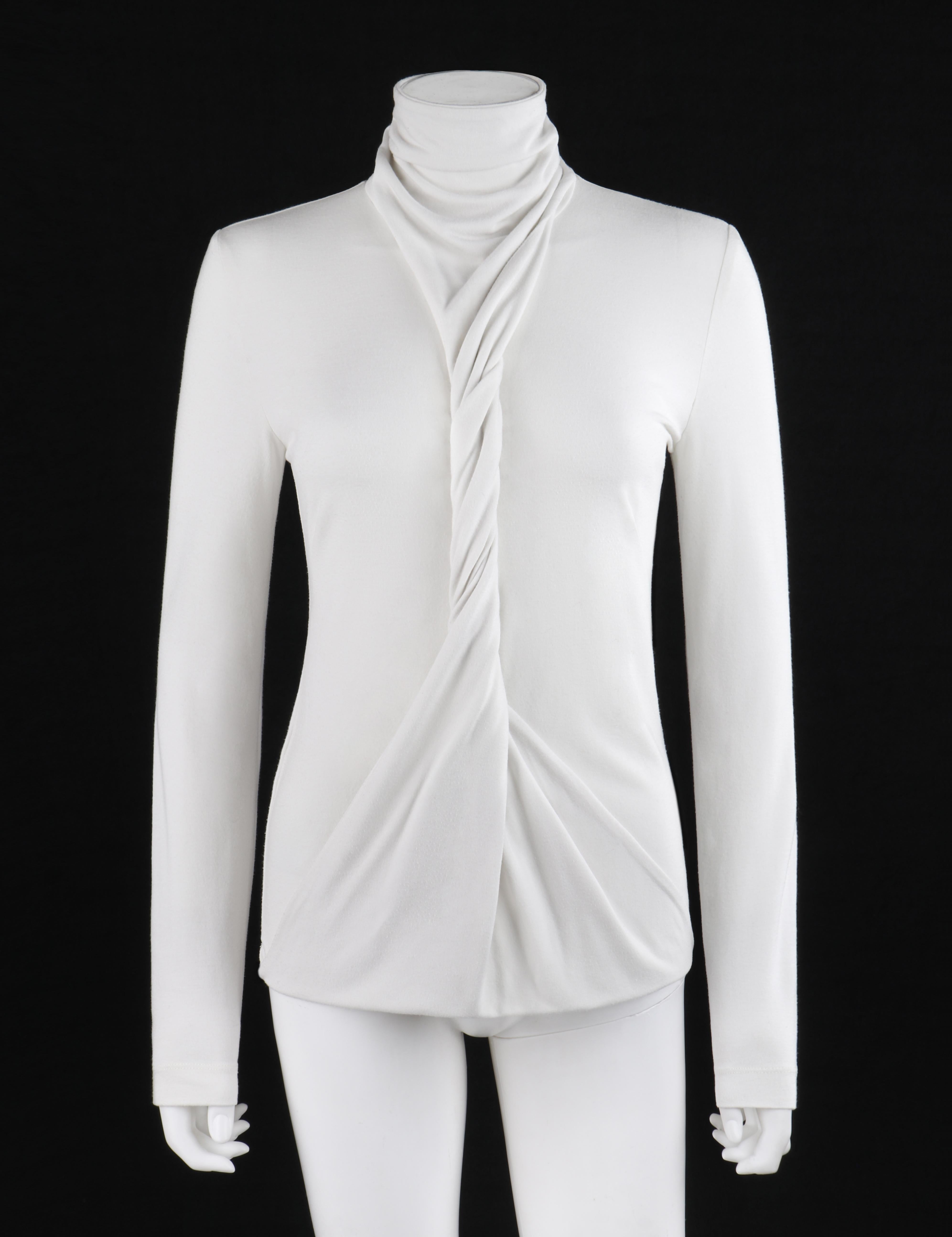 ALEXANDER McQUEEN S/S 2000 “Eye” White Convertible Twisted Front High Neck Top
 
Brand / Manufacturer: Alexander McQueen
Collection: S/S 2000 “Eye” 
Designer: Alexander McQueen
Style: Long sleeve top
Color(s): White
Lined: No
Marked Fabric Content: