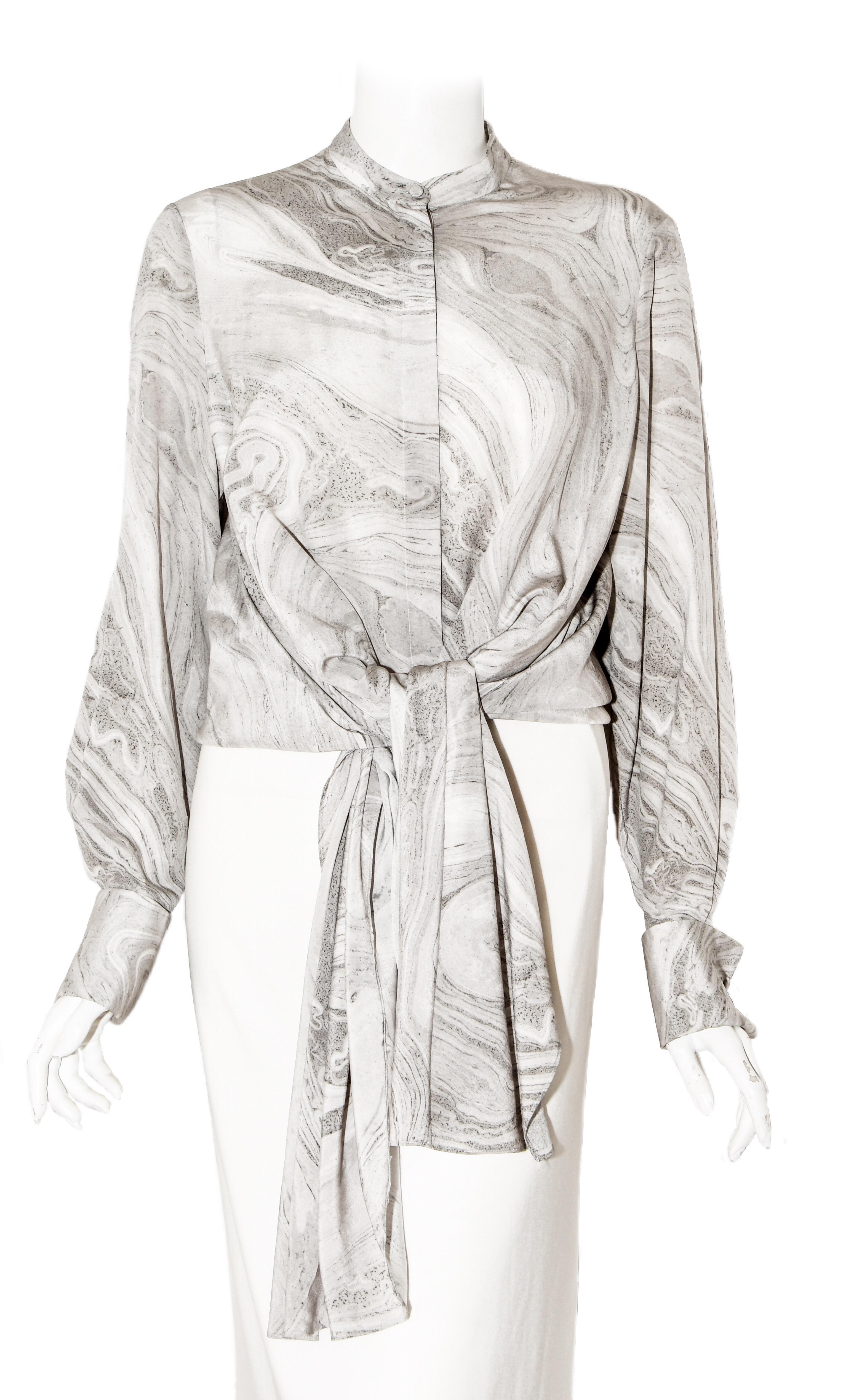 Alexander McQueen silk grey marble design blouse with mandarin collar incorporates long sleeves with up cuffs and covered cuffling style buttons.  With front button closure and asymmetric hem longer at the sides, this oversize blouse is modern and
