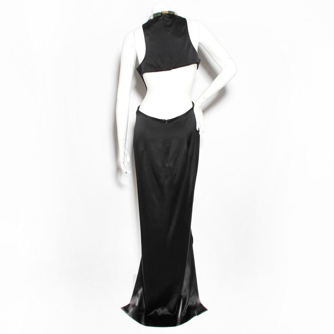 Silk jeweled gown by Alexander McQueen
Black silk
Multicolored jewel neckline 
Bust and waist cutouts 
Open back 
Front slit 
Zip back closure
Clasp neck closure 
Made in Italy 
Condition: Excellent condition, small pulls in fabric. (see photo)