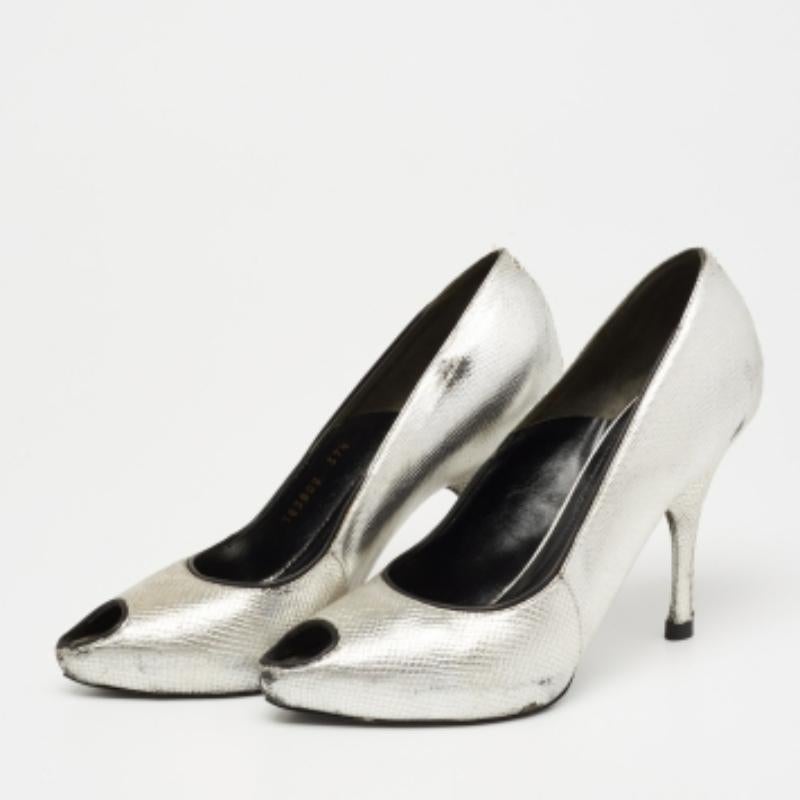 Constructed from lizard-embossed leather, this pair of pumps is worthy of a place in your wardrobe. It is stacked upon 10.5cm heels and embodies a peep-toe silhouette.