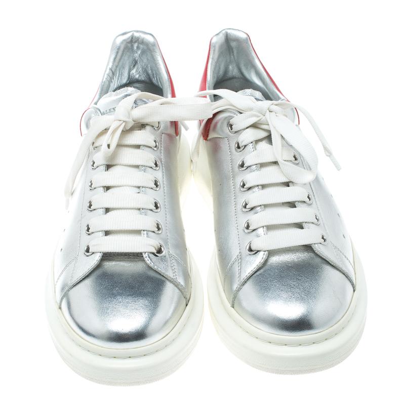 Flaunt your high-style with these trendy sneakers from Alexander McQueen! They've been carefully crafted from leather in an amazing combination of red and silver hues, high platforms and laces on the vamps. You are sure to receive both comfort and