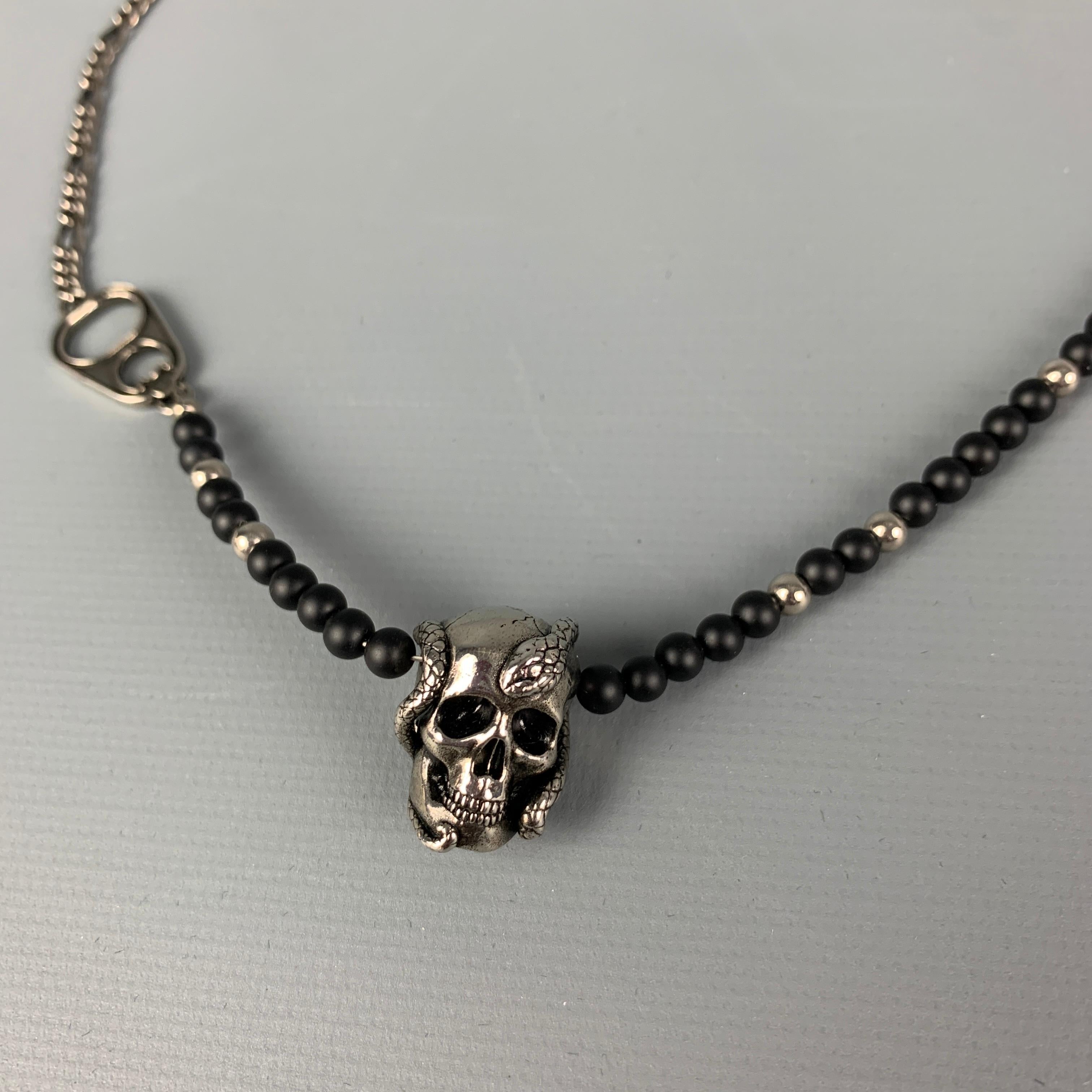ALEXANDER MCQUEEN necklace comes in a silver tone metal chain link featuring black beads, skull detail, and a clasp closure. Comes with box. 

Excellent Pre-Owned Condition.

Measurements:

Length: 20 in. 