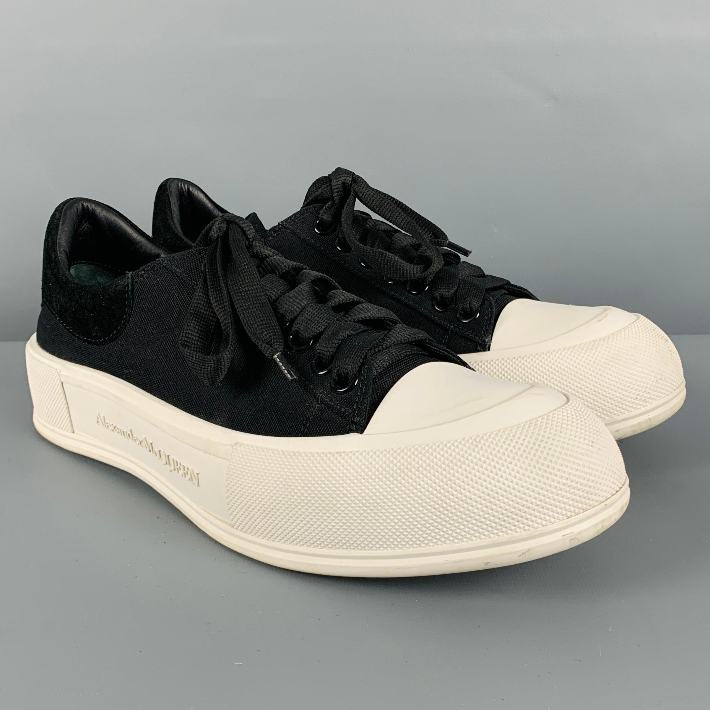 ALEXANDER MCQUEEN sneakers
in black canvas fabric featuring a two tone low top style, velvet heel detail, chunky rubber sole, and lace-up closure. Made in Italy.Very Good Pre-Owned Condition. Moderate signs of wear. 

Marked:   43Outsole: 12 x 4.25