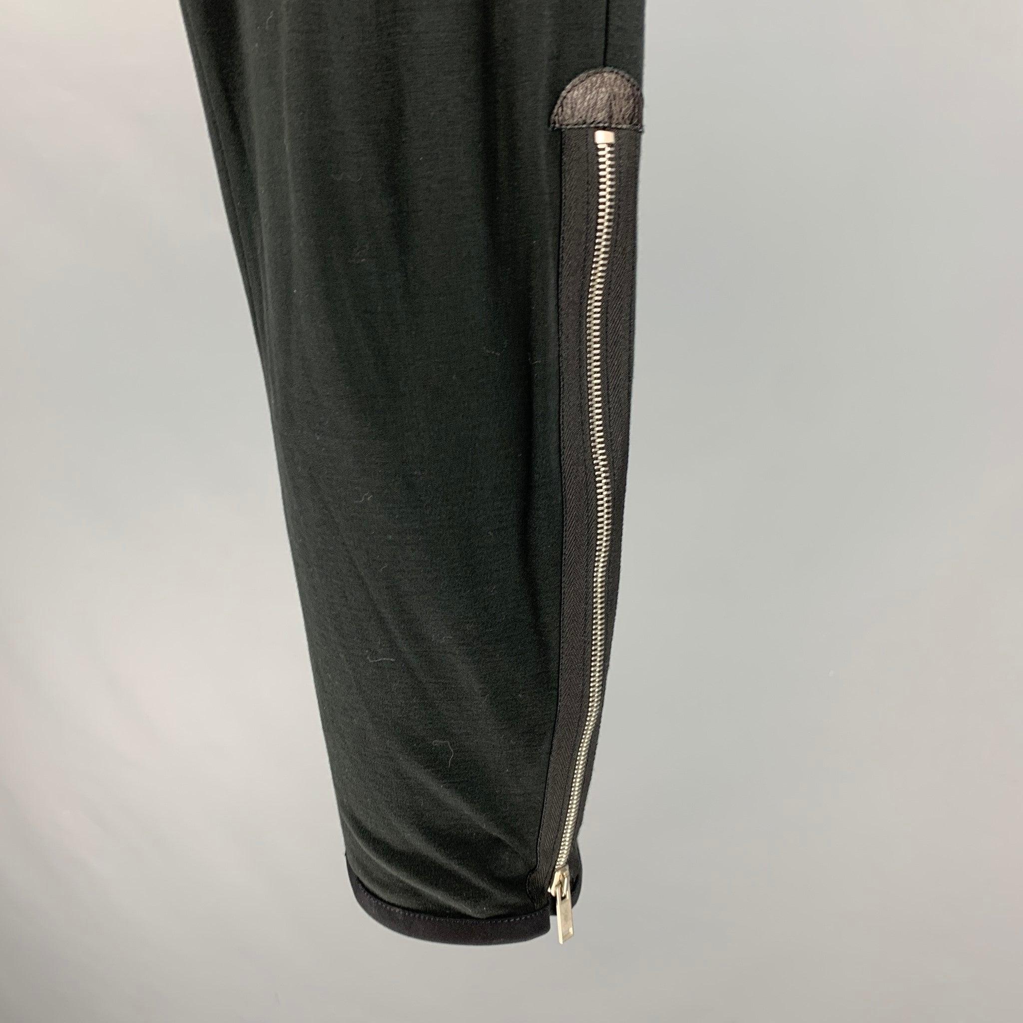 ALEXANDER MCQUEEN dress pants
in a black cotton cashmere blend fabric featuring side zippers and a button fly closure. Made in Hungary.Very Good Pre-Owned Condition. Minor marks. 

Marked:   48 

Measurements: 
  Waist: 32 inches Rise: 9 inches