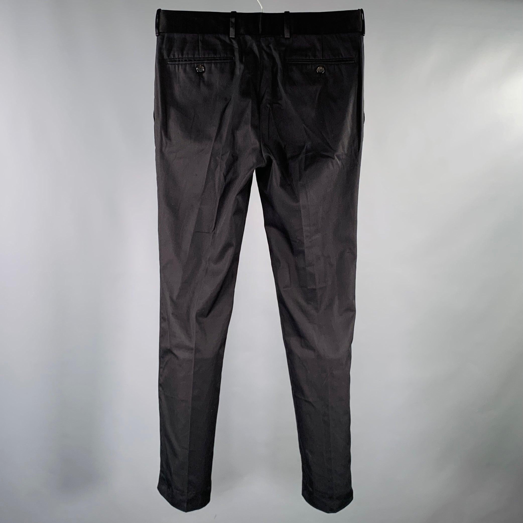 ALEXANDER MCQUEEN dress pants
in a black cotton woven fabric featuring a flat front style, straight leg, and zip fly closure. Made in Romania.Excellent Pre-Owned Condition. 

Marked:   IT 46 

Measurements: 
  Waist: 32 inches Rise: 8.5 inches