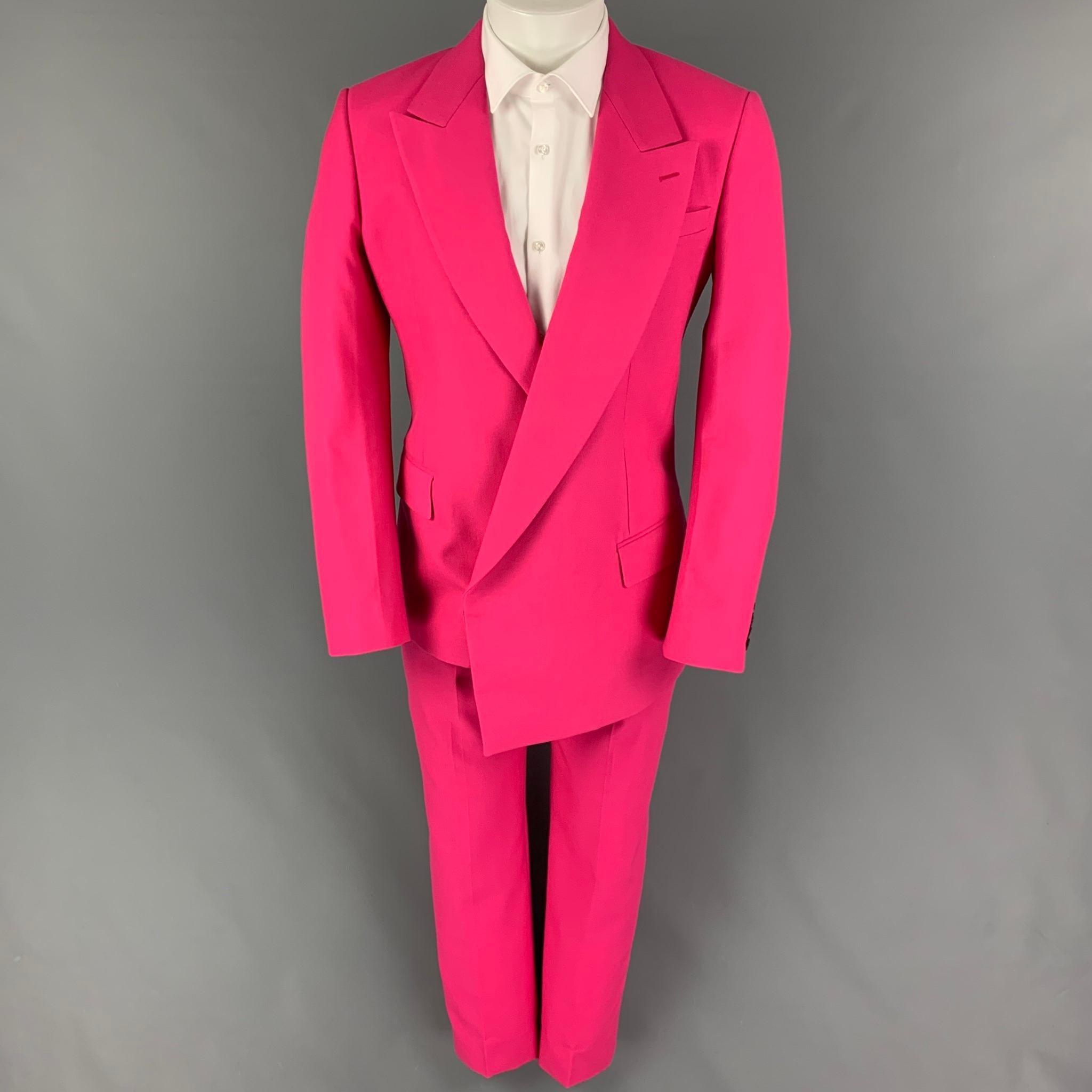ALEXANDER McQUEEN suit comes in a pink wool with a full liner and includes a single breasted,  asymmetrical double breasted sport coat with a peak lapel and matching flat front trousers. Made in Italy.

New with tags.
Marked: 46
Original Retail