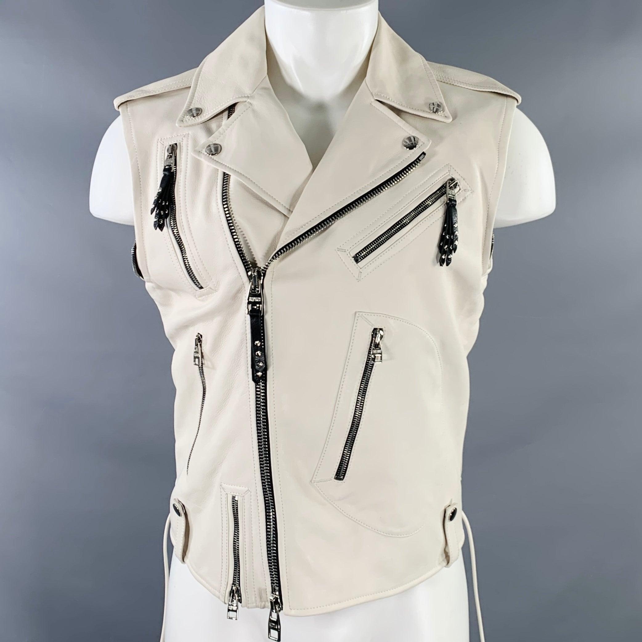 ALEXANDER MCQUEEN jacket
in an off white leather featuring a biker style, multiple zip pockets with black leather tassel details, detachable sleeves for the option of wearing as a vest, and zip up closure. Made in Italy.Very Good Pre-Owned