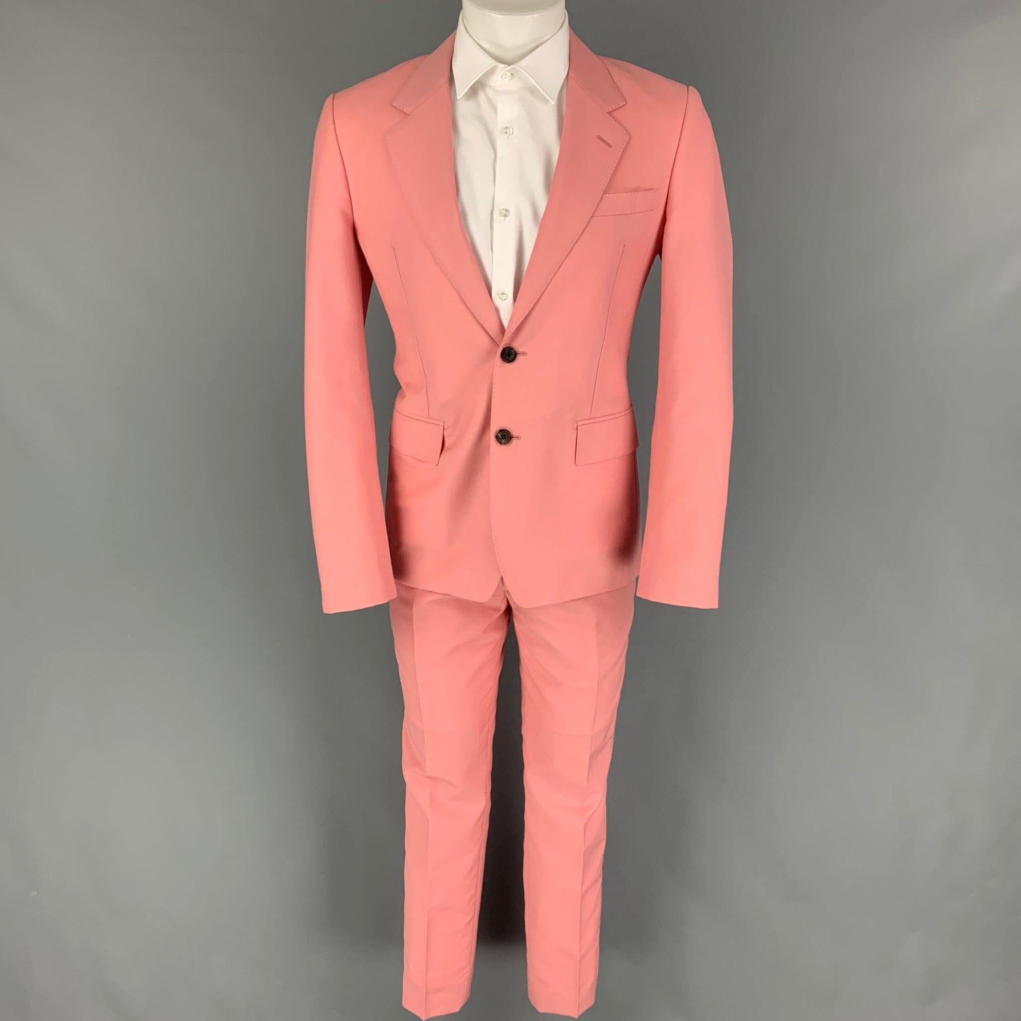 ALEXANDER McQUEEN
suit comes in a pink wool / mohair with a full liner and includes a single breasted,
 double button sport coat with a notch lapel and matching flat front trousers. Made in Italy. Excellent Pre-Owned Condition. 

Marked:   48