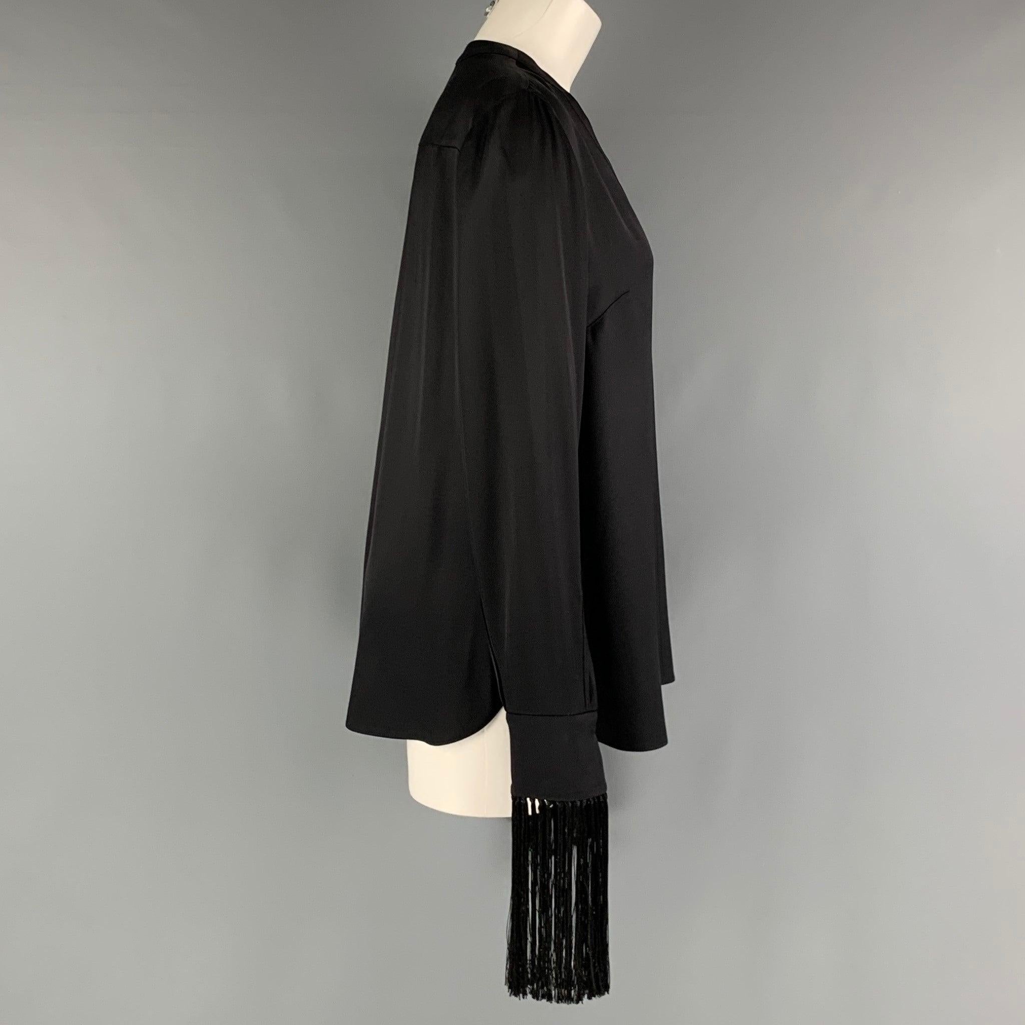 ALEXANDER MCQUEEN shirt comes in a black silk woven material featuring open collar, fringe at sleeves and a button up closure. Made in Italy. Excellent Pre-Owned Condition.  

Marked:   40 

Measurements: 
 
Shoulder: 18 inches Bust: 42 inches