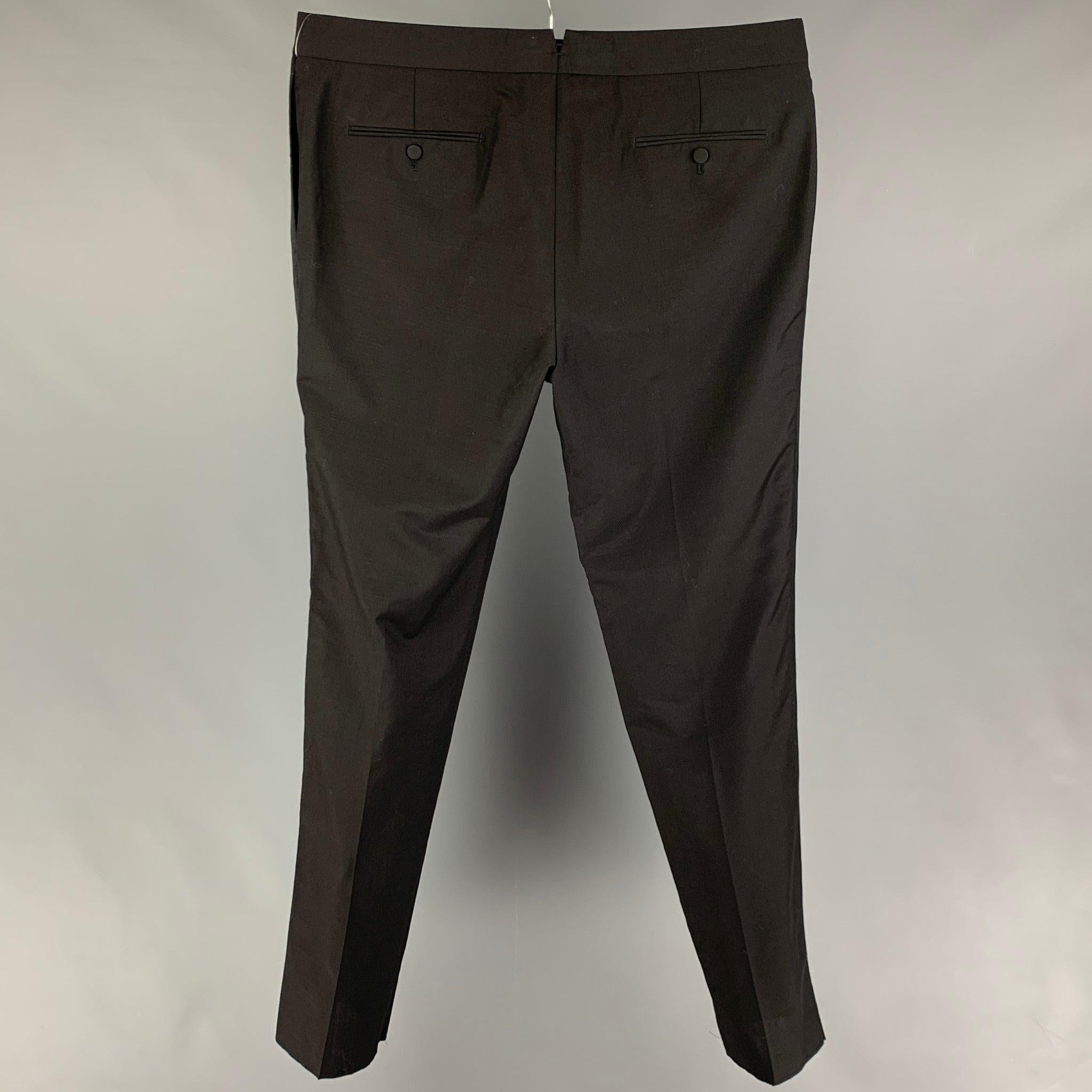 ALEXANDER McQUEEN tuxedo pants comes in a black wool / mohair featuring a flat front, ribbon trim, front tab, and a zip fly closure. Made in Italy.
Excellent
Pre-Owned Condition. 

Marked:  58 

Measurements: 
 Waist: 40 inches Rise:
12.5 inches