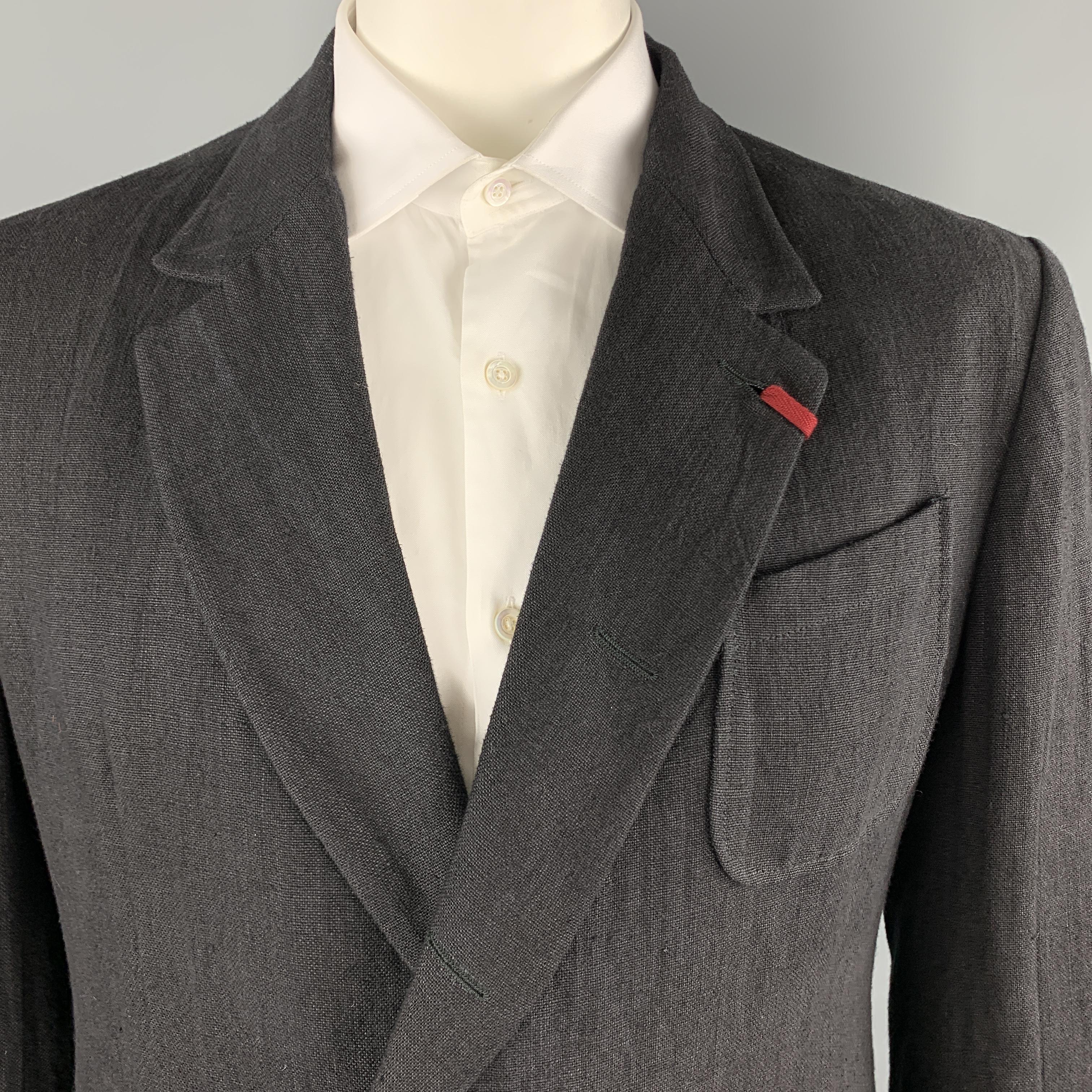 ALEXANDER MCQUEEN sport coat comes in black textured linen with a red tab detailed notch lapel, single breasted, hidden two button front, and  functional button cuffs. Made in Italy.

Excellent Pre-Owned Condition.
Marked: IT