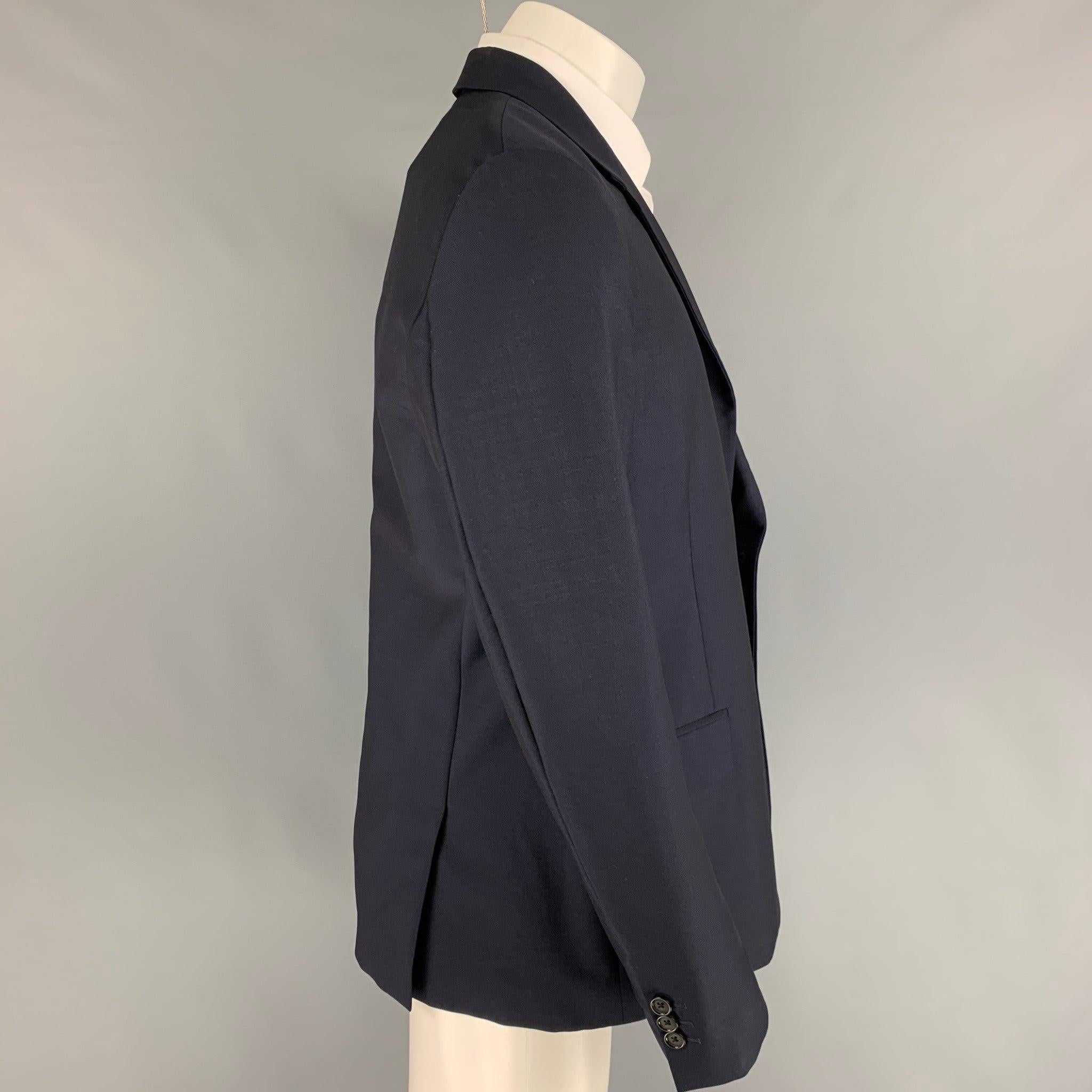 ALEXANDER McQUEEN sport coat comes in a navy wool with a full liner featuring a notch lapel, flap pockets, double back vent, and a double button closure. Made in Italy.
Excellent
Pre-Owned Condition.  

Marked:   52 

Measurements: 
 
Shoulder: 18