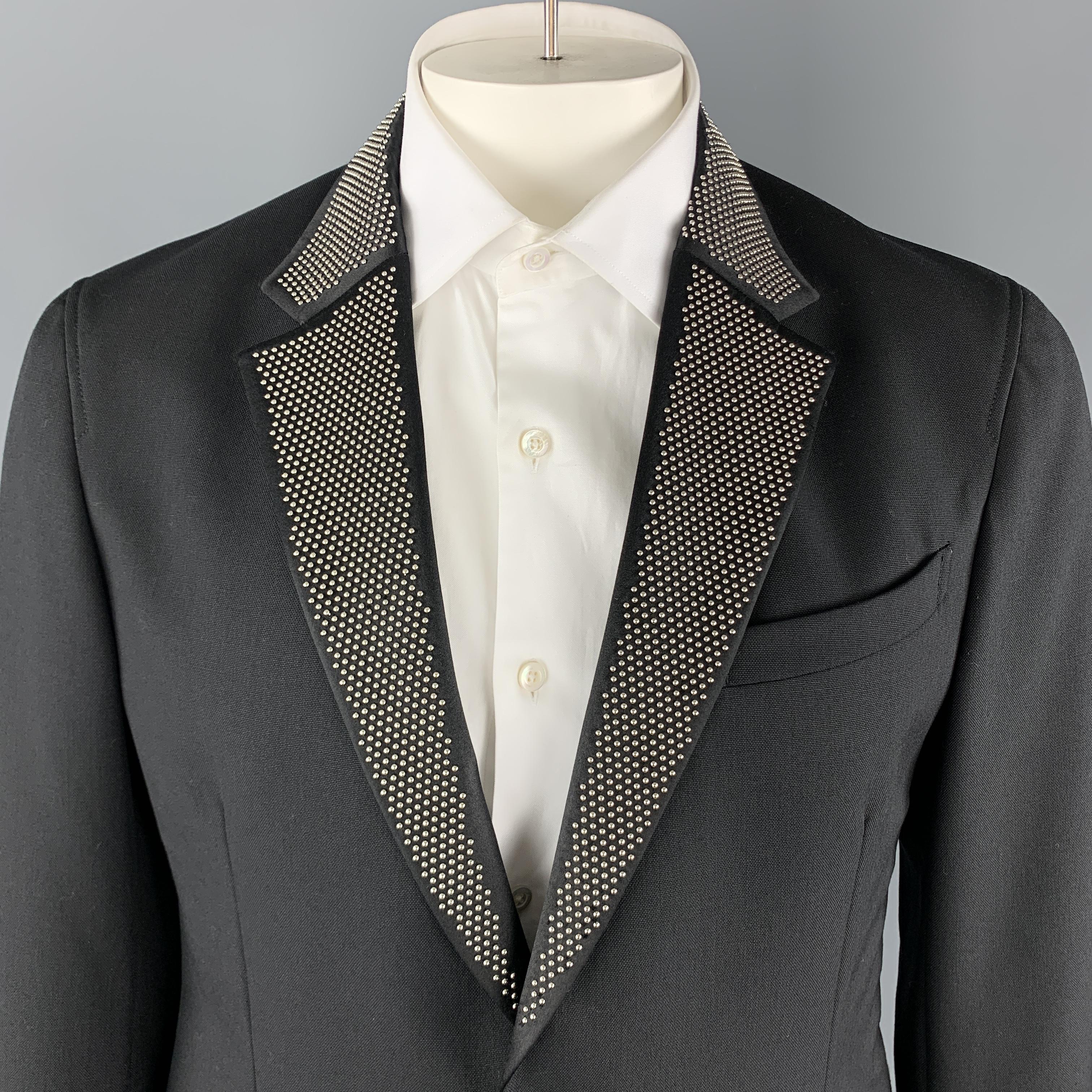 ALEXANDER MCQUEEN Sport Coat comes in a solid black wool / mohair material, with a studded lapel, two buttons at closure, slit and zip pockets, unbuttoned cuffs and a single vent at back, unlined. Made in Italy.

Excellent Pre-Owned