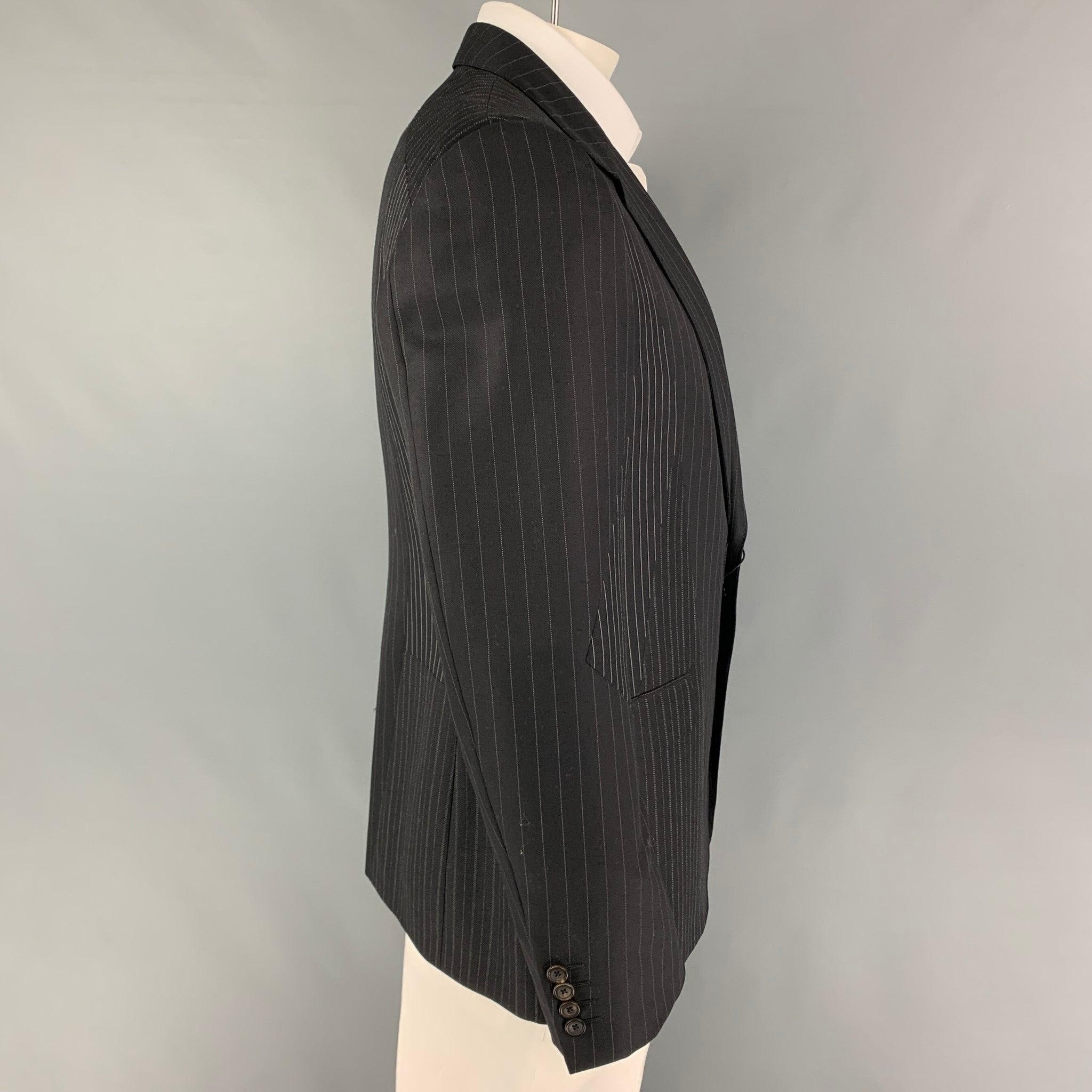 ALEXANDER McQUEEN sport coat comes in a black & white patchwork wool with a full liner featuring a notch lapel, flap pockets, single back vent, and a double button closure. Made in Italy.
New With Tags.
 

Marked:   54 

Measurements: 
 
Shoulder: