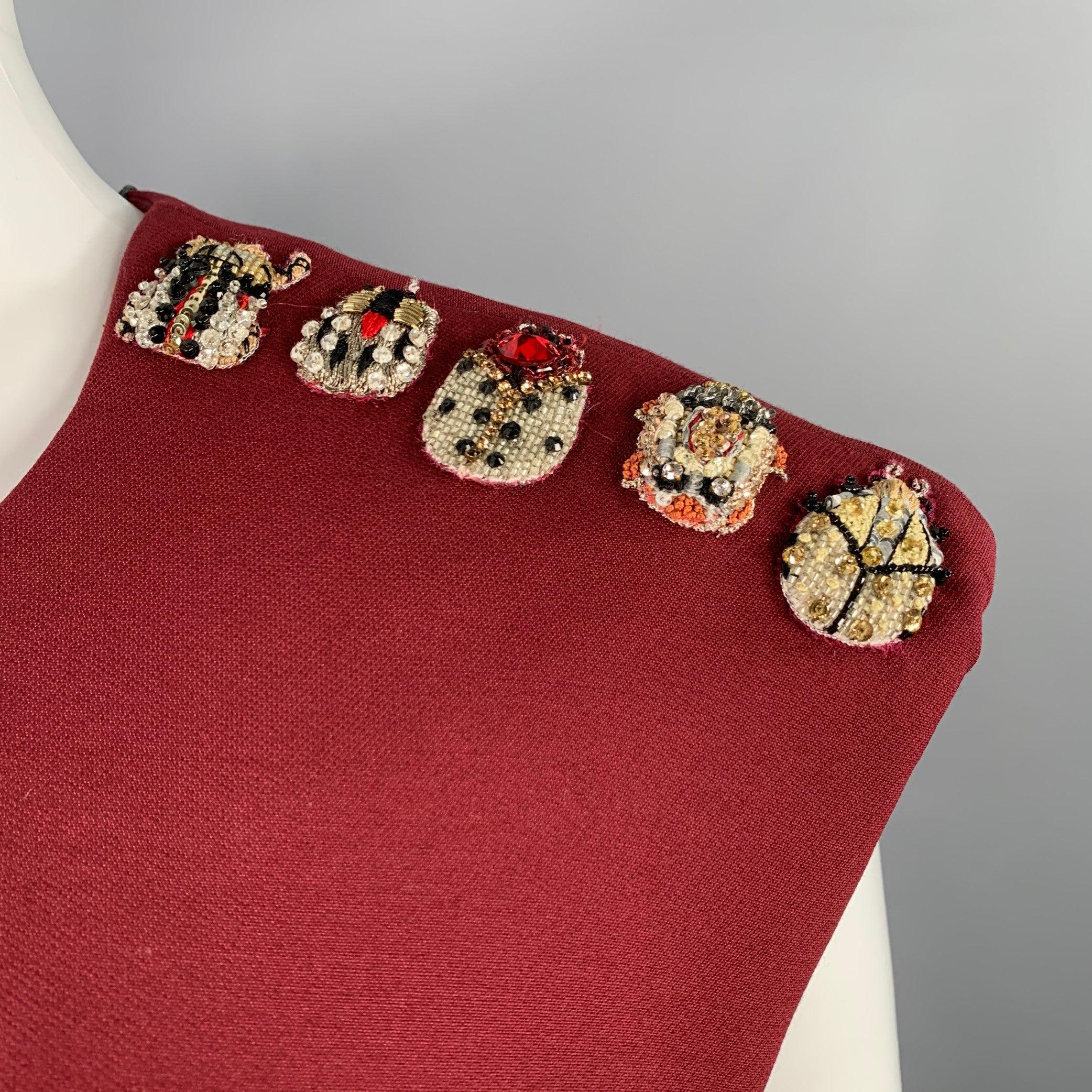 ALEXANDER MCQUEEN dress
in a burgundy wool silk blend featuring a sleeveless style with padded shoulders, gold tone beaded shoulder appliques, and invisible back zipper closure. Made in Italy.New with Tags. 

Marked:   IT 42 

Measurements: 

