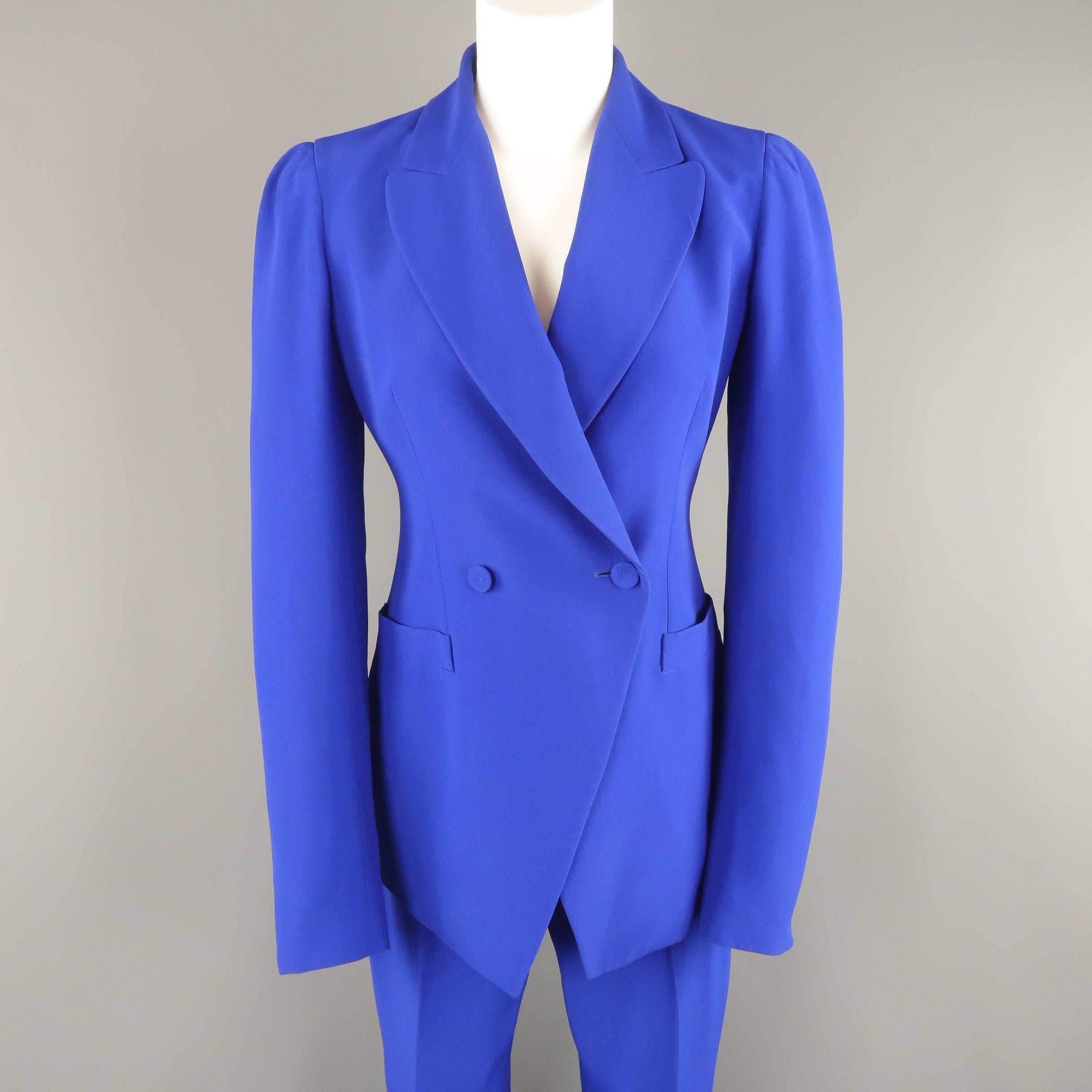 ALEXANDER MCQUEEN pants suit comes in bold cobalt blue crepe and includes a double breasted, peak lapel, pleated shoulder sport jacket and matching flat front flared trousers. Made in Italy.
 
Very Good Pre-Owned Condition.
Marked: Blazer: IT 42