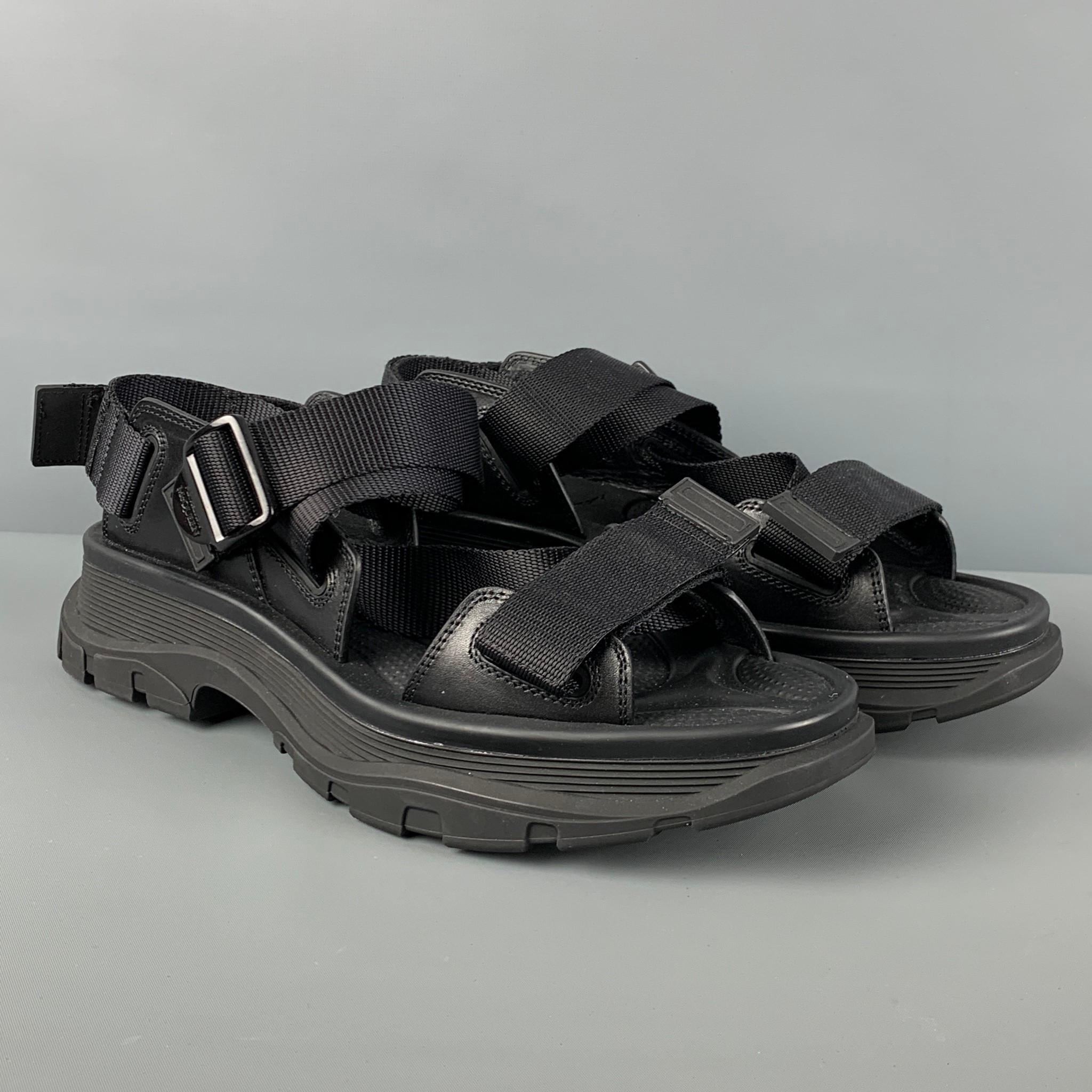 ALEXANDER McQUEEN sandals comes in a black material with a leather trim featuring a adjustable strap and a chunky rubber sole. Includes box.

Excellent Pre-Owned Condition.
Marked: 42.5
Original Retail Price: $690.00

Outsole: 12.5 in. x 5 in.