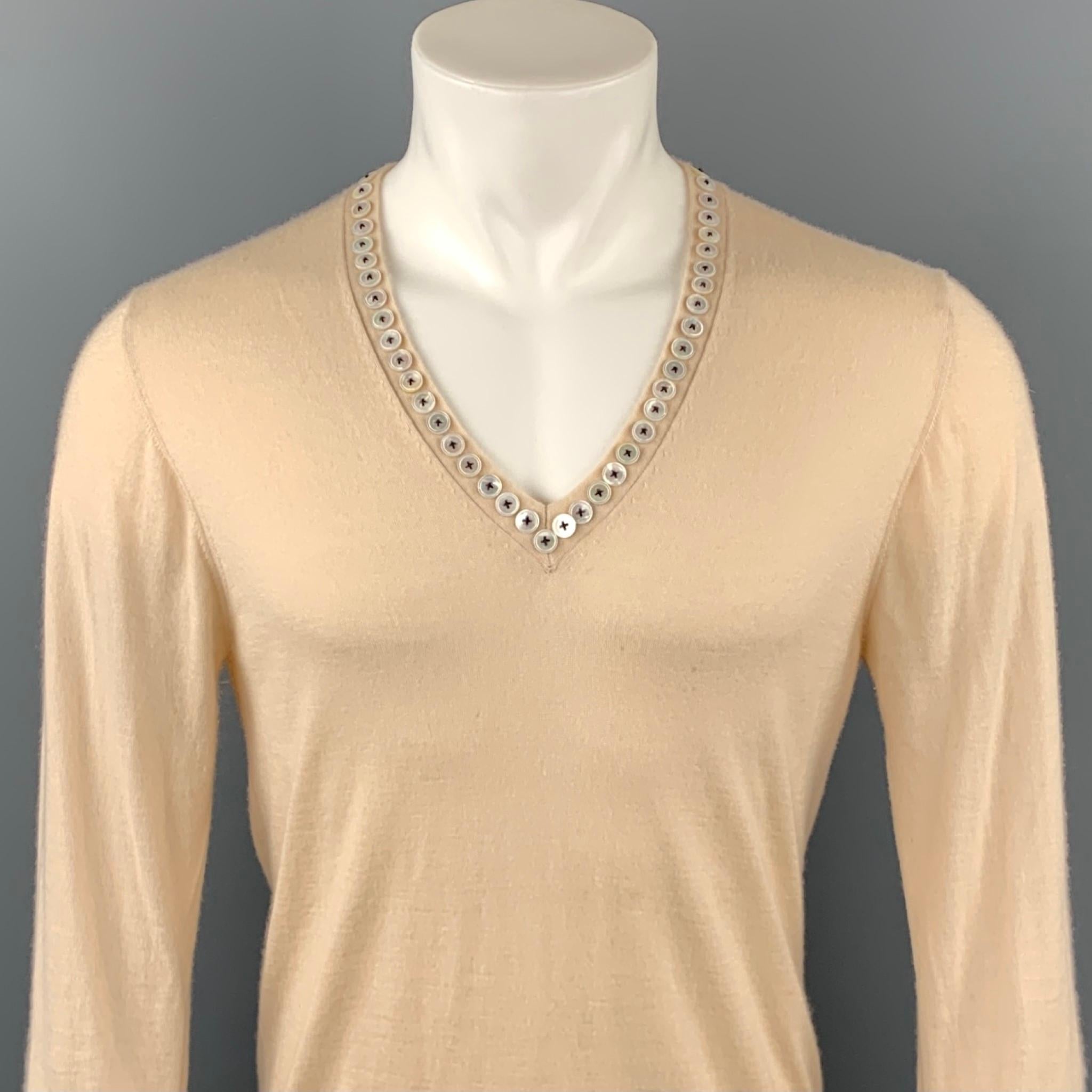 ALEXANDER McQUEEN sweater comes in a beige cashmere featuring a buttoned embellished v-neck. Minor discoloration. Made in Italy.

Very Good Pre-Owned Condition.
Marked: L

Measurements:

Shoulder: 17 in. 
Chest: 38 in. 
Sleeve: 28 in. 
Length: 26.5