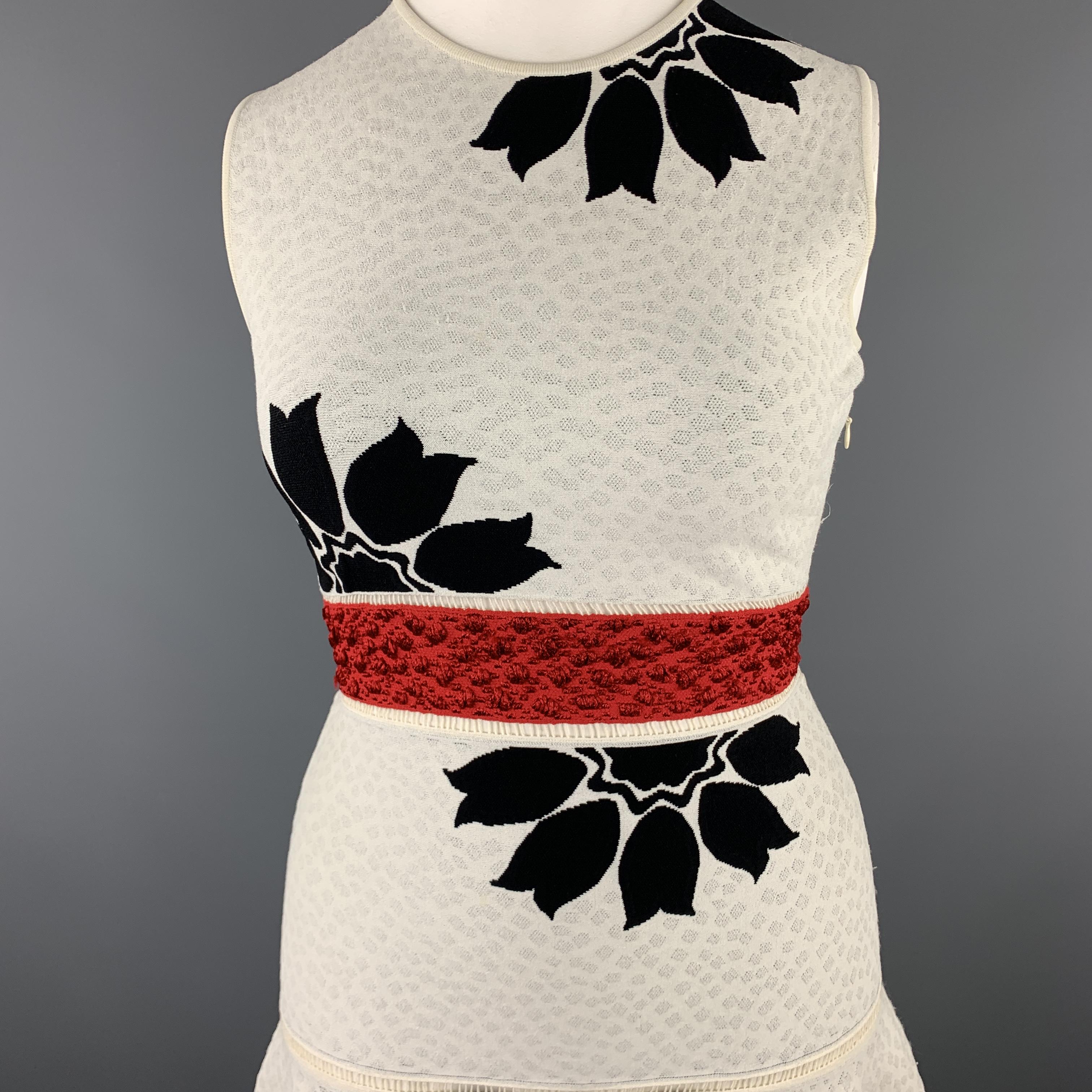ALEXANDER MCQUEEN cocktail dress comes in off white textured stretch knit with a black floral pattern throughout, red belt panel, fit to flair ruffled skirt, and cutout trim. Made in Italy.

Excellent Pre-Owned Condition.
Marked: