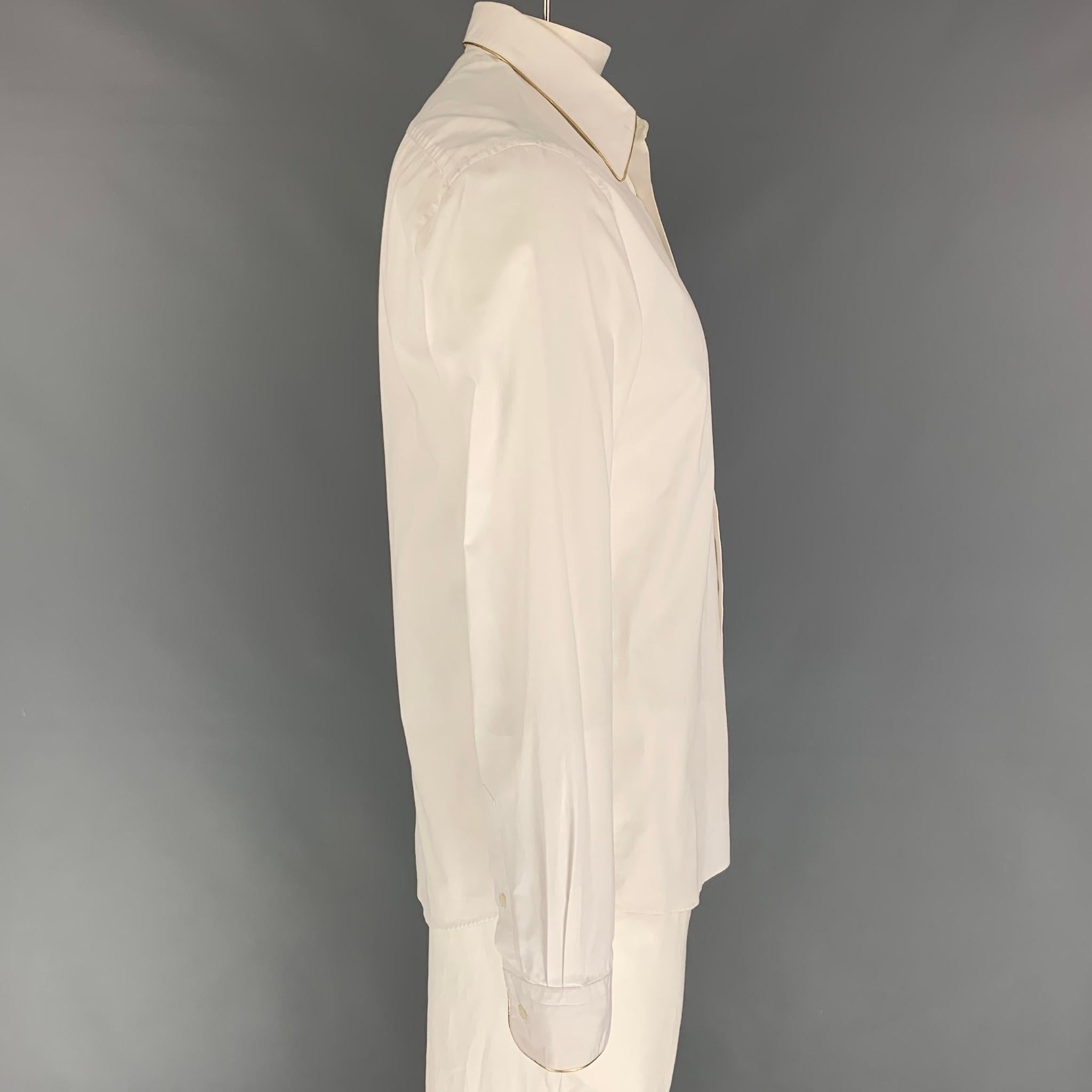 ALEXANDER McQUEEN long sleeve shirt comes in a white cotton with a gold trim featuring a spread collar and a button up closure. Made in Romania. 

Good Pre-Owned Condition. Minor discoloration at neckline and under arms.
Marked: