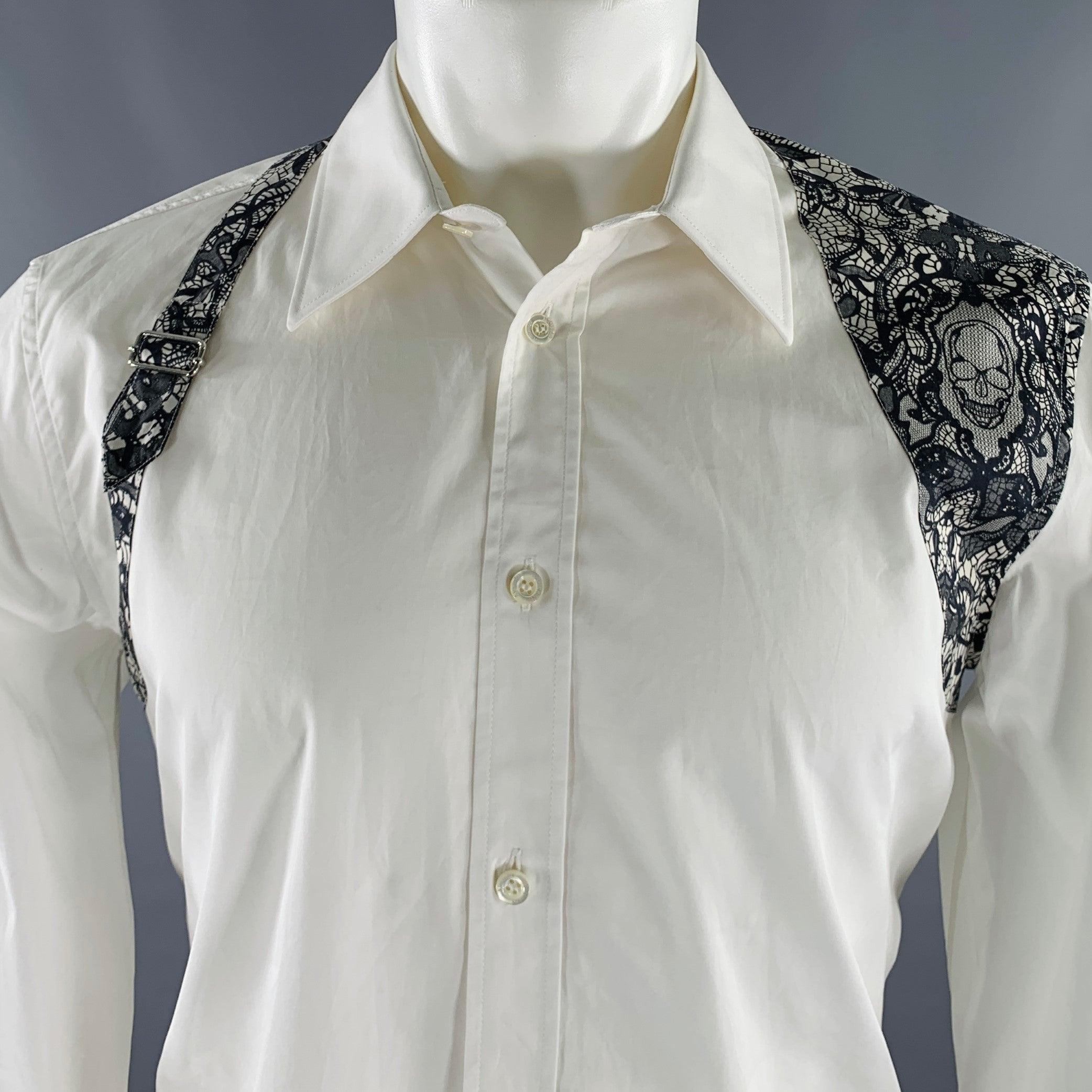 ALEXANDER MCQUEEN long sleeve shirt
in a white cotton woven fabric featuring a black printed lace harness design with silver tone buckle detail, and button closure. Made in Romania.Very Good Pre-Owned Condition. Minor mark. 

Marked:   16+