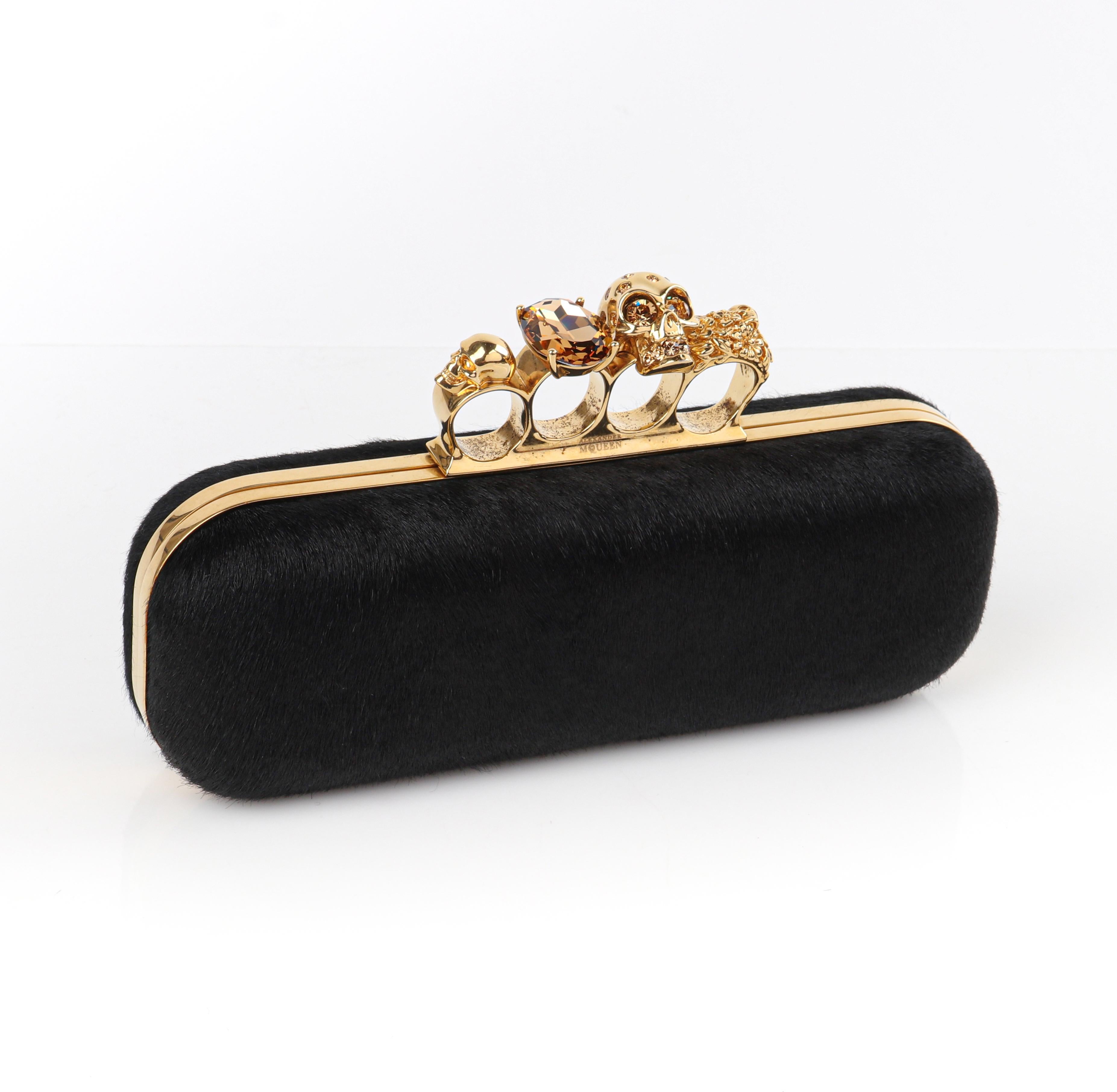 ALEXANDER McQUEEN Black Pony Hair Skull & Citrine Knuckle Duster Box Clutch
 
Estimated Retail: $1251.00
 
Brand / Manufacturer: Alexander McQueen
Manufacturer Style Name: Knuckle Duster
Style: Box clutch
Color(s): Black (exterior, interior); gold