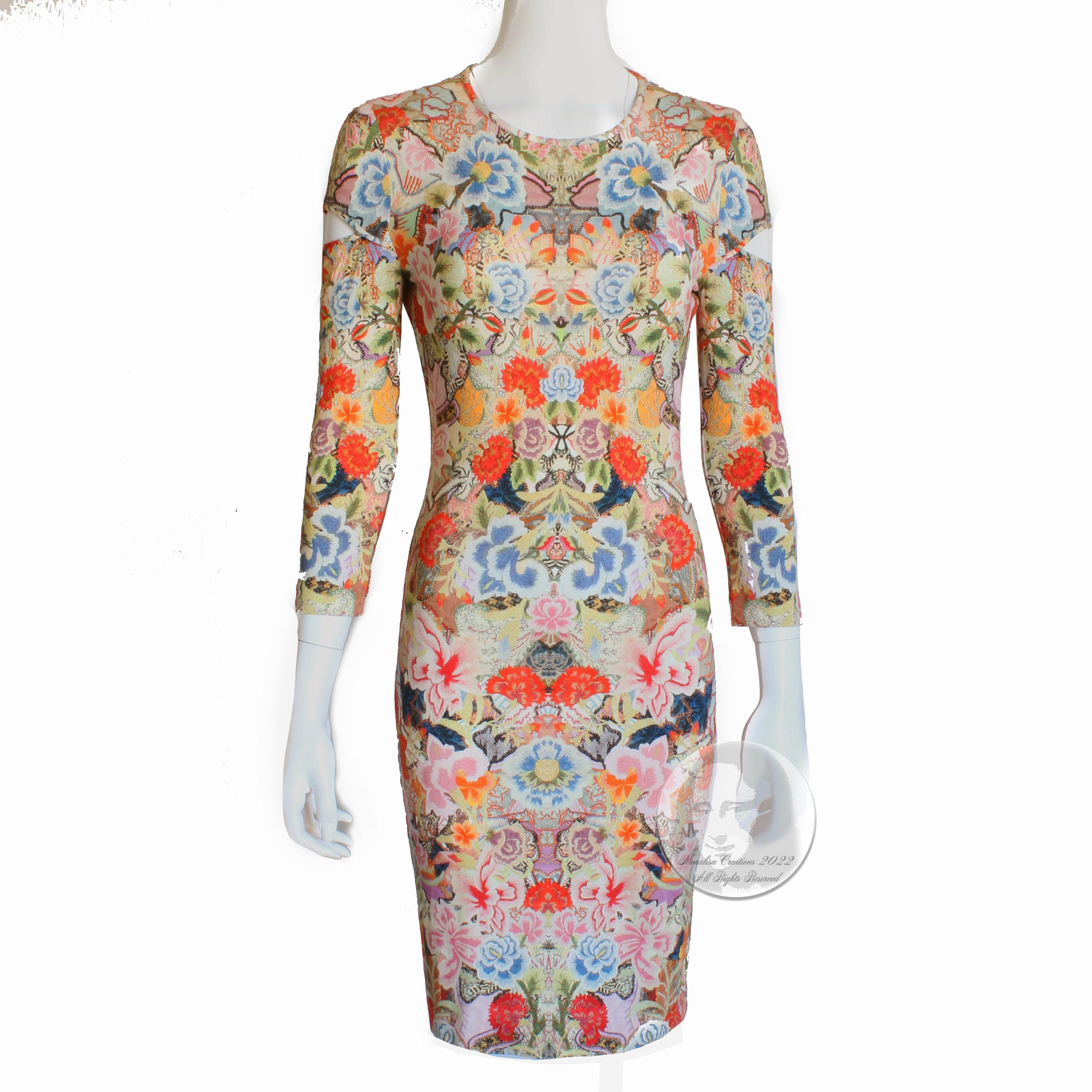 Authentic, preowned Alexander McQueen slash sleeve cutout dress with abstract kaleidoscope floral print from the 2014 collection. Made from a rayon/elastane blend fabric, this dress fits like a glove and is designed to show off your curves! 

With