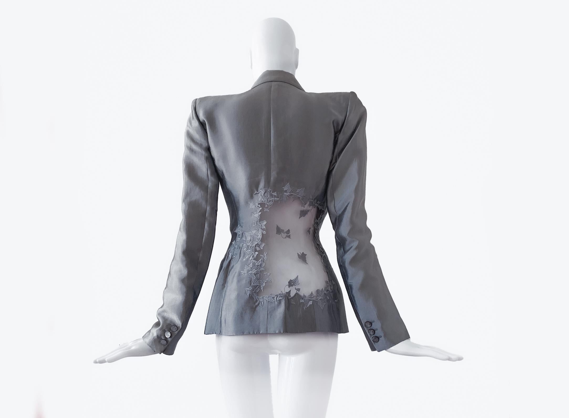 
Rare archival Collectors' Piece.
Showstopper
Gorgeous Alexander McQueen Ensemble. Legendary Spring Summer 1999 Collection runway look as skirtsuit in silver.
Silk ensemble from his documented 1999 collection. This highly stylized piece is a perfect