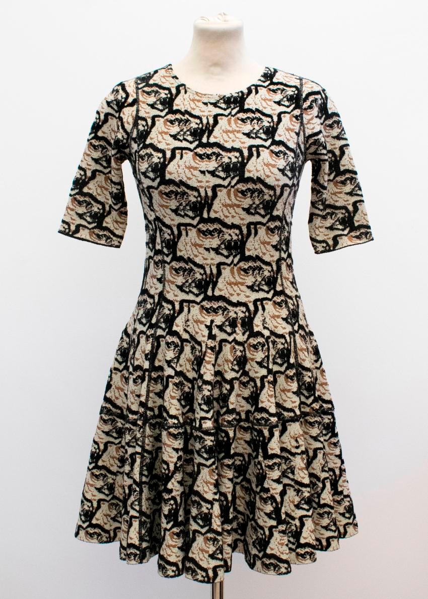 Alexander McQueen stretch-knit tiger skater dress. 

Mid-weight textured knit dress with a fitted bodice and flare skirt in an all-over tiger print. 

Please note, these items are pre-owned and may show signs of being stored even when unworn and